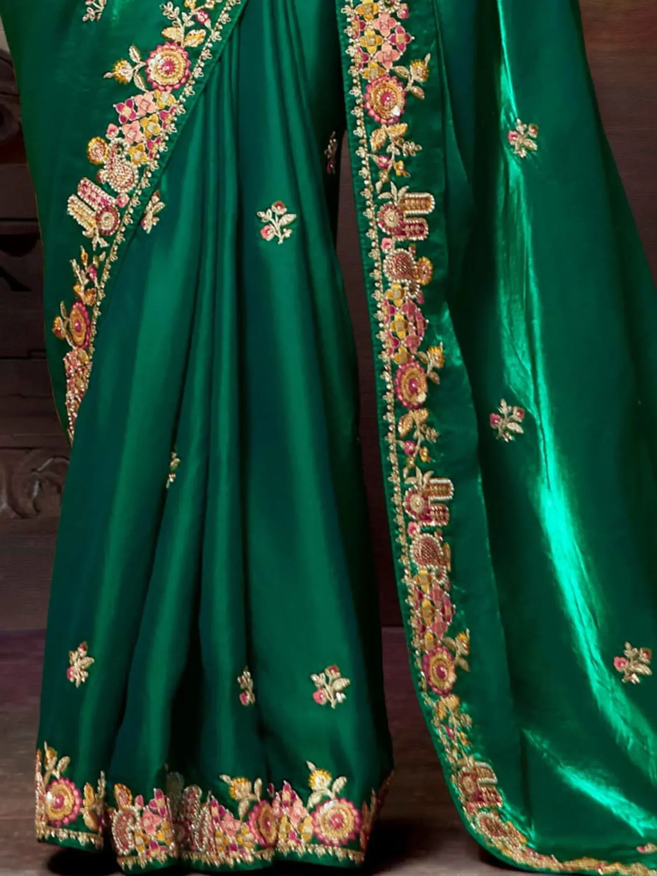 Emerald green designer lehenga with floral embroidery and gold detailing for Indian ethnic wear