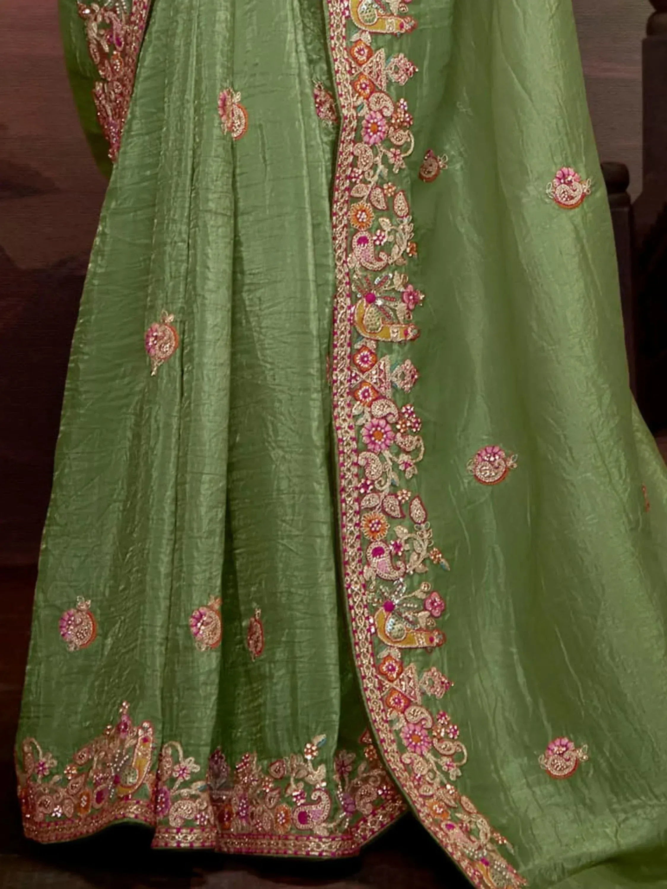 Green designer lehenga with intricate floral and paisley embroidery, perfect for Indian ethnic wear.