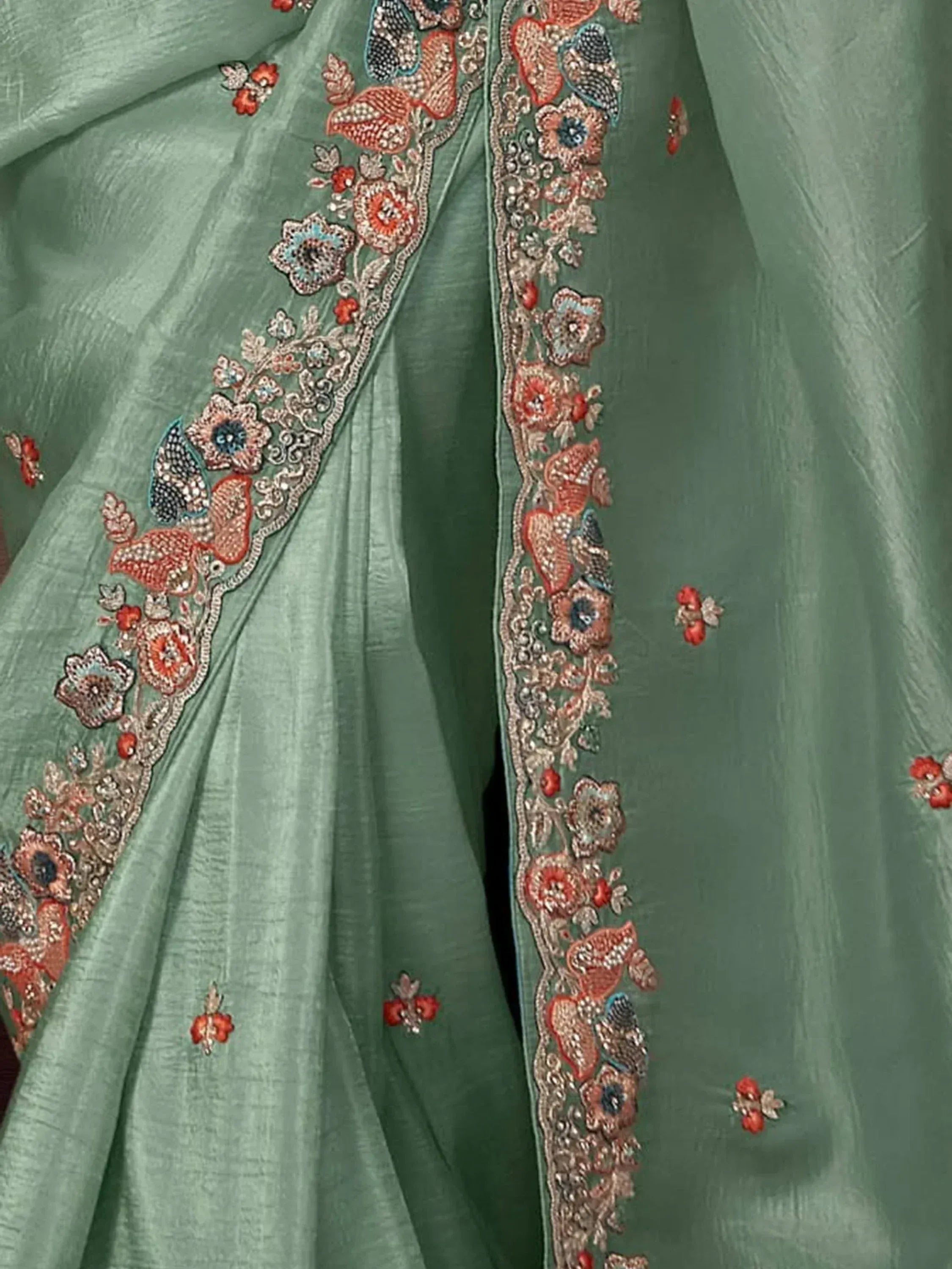 Mint green ethnic saree with intricate floral embroidery and beadwork details