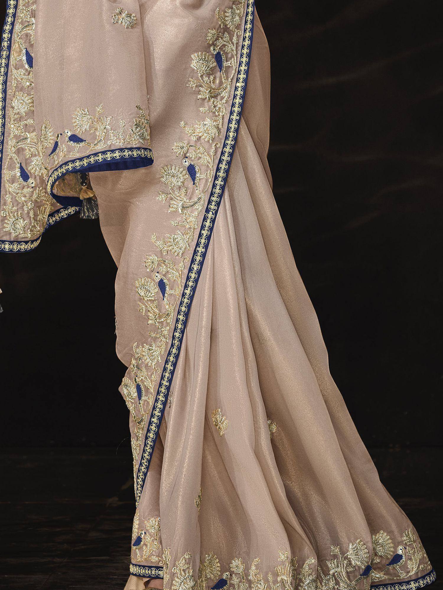 Beige saree with gold and blue peacock embroidery, elegant Indian ethnic wear