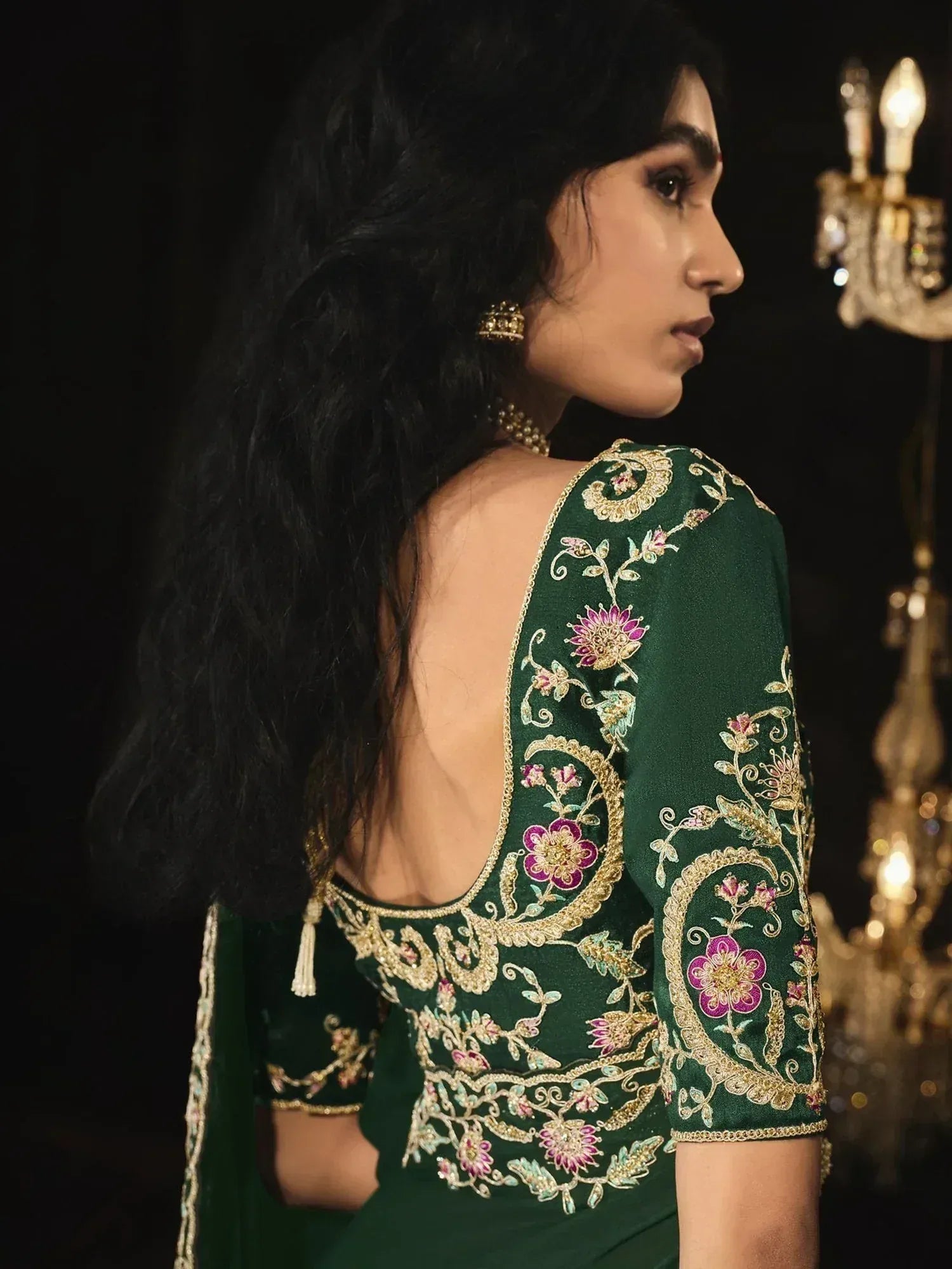 Emerald green designer lehenga choli with floral embroidery and open back, perfect for Indian ethnic wear