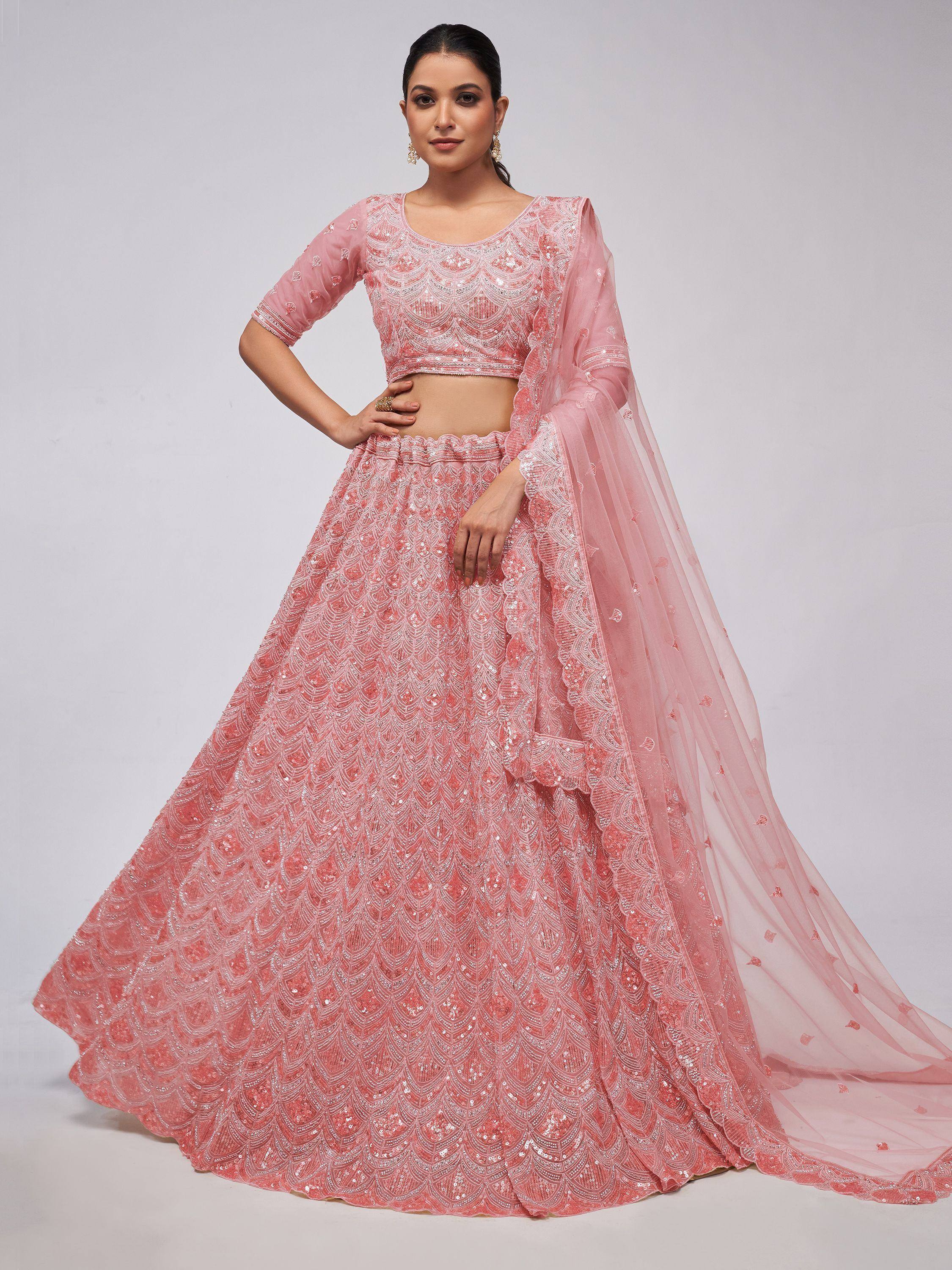 Pink designer lehenga choli with intricate embroidery and sheer dupatta, perfect for Indian ethnic wear occasions.