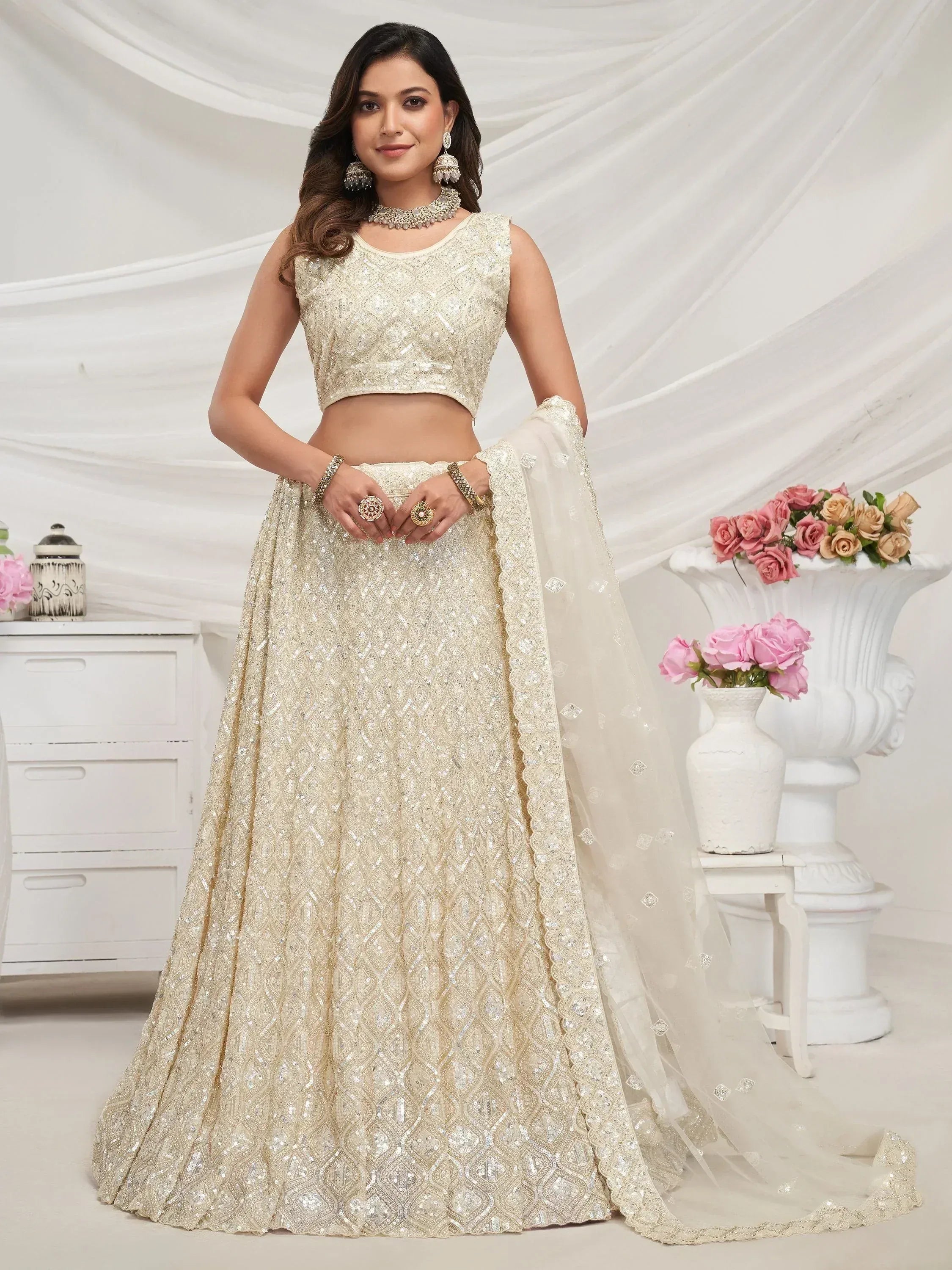 Elegant ivory lehenga choli with intricate embroidery and sequin work, perfect for Indian weddings and festive occasions.