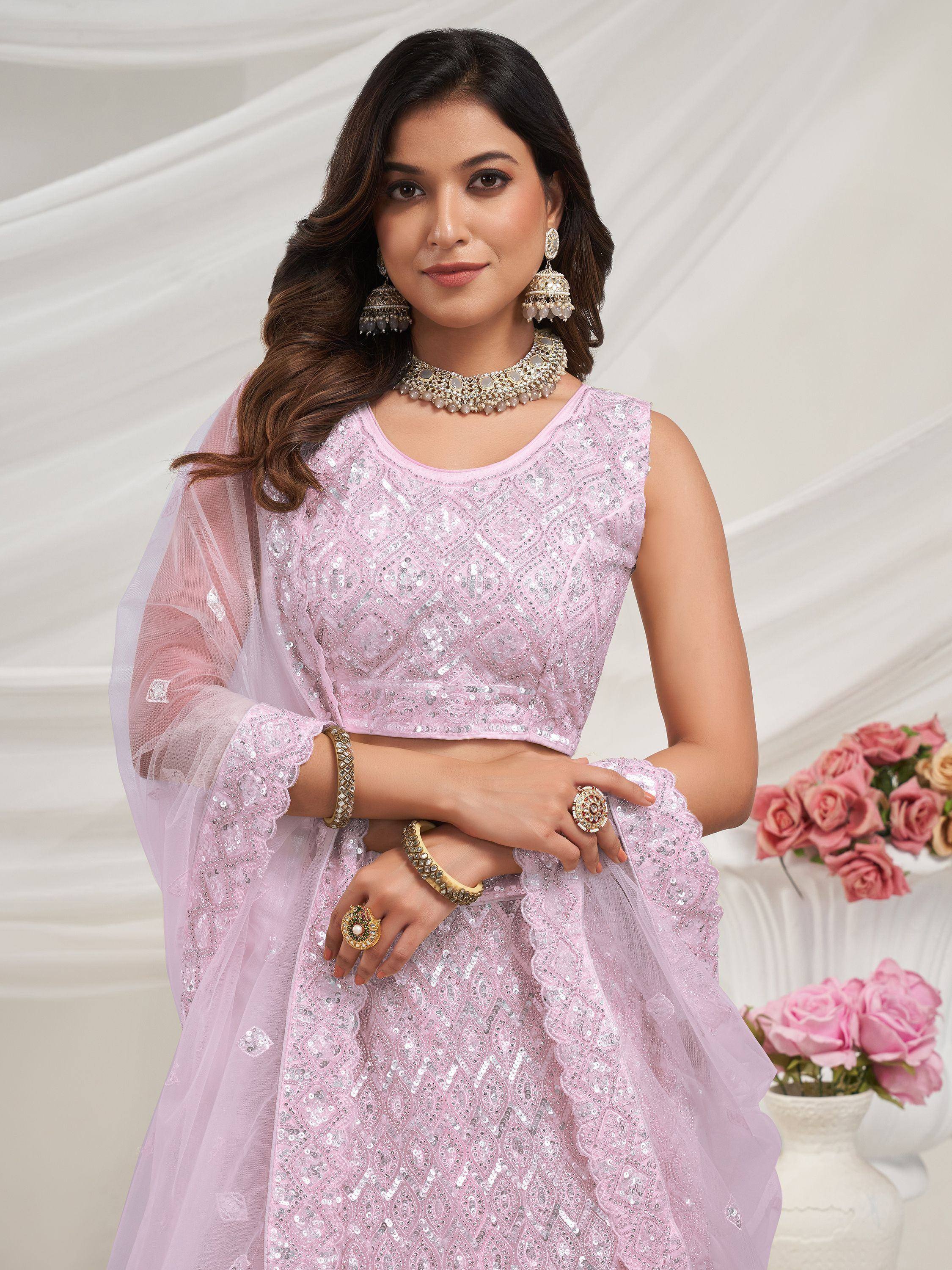 Pink sequined lehenga choli with matching dupatta and traditional jewelry