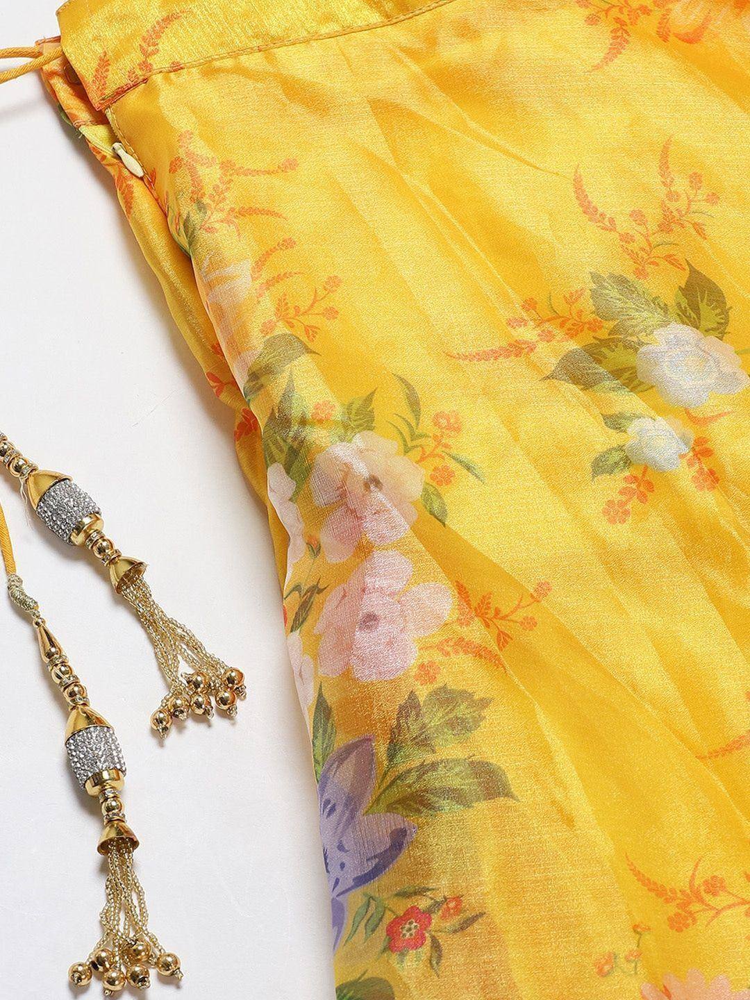Yellow floral printed ethnic gown with embellished tassels, perfect for Indian occasions