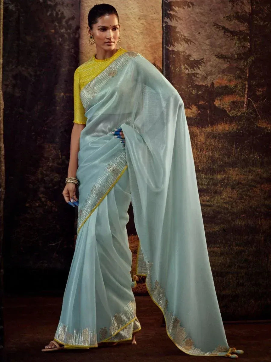 Light blue designer saree with gold border and yellow blouse, elegant ethnic wear for women