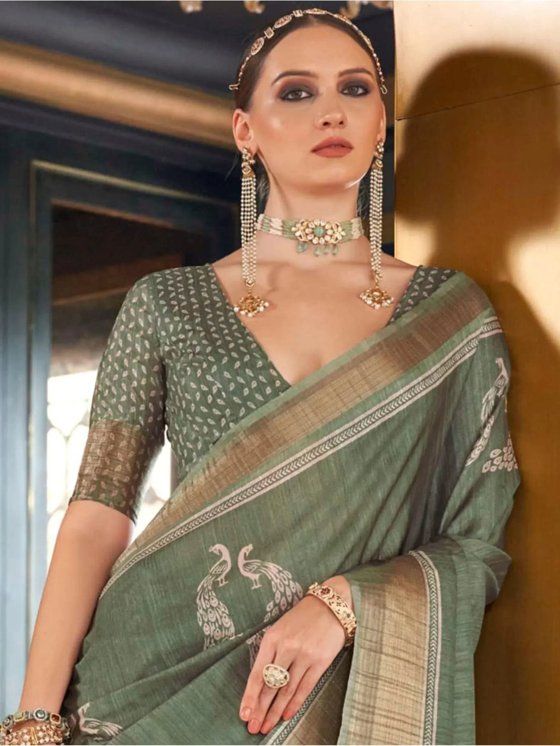 Elegant green saree with peacock print, traditional Indian ethnic wear, styled with gold jewelry