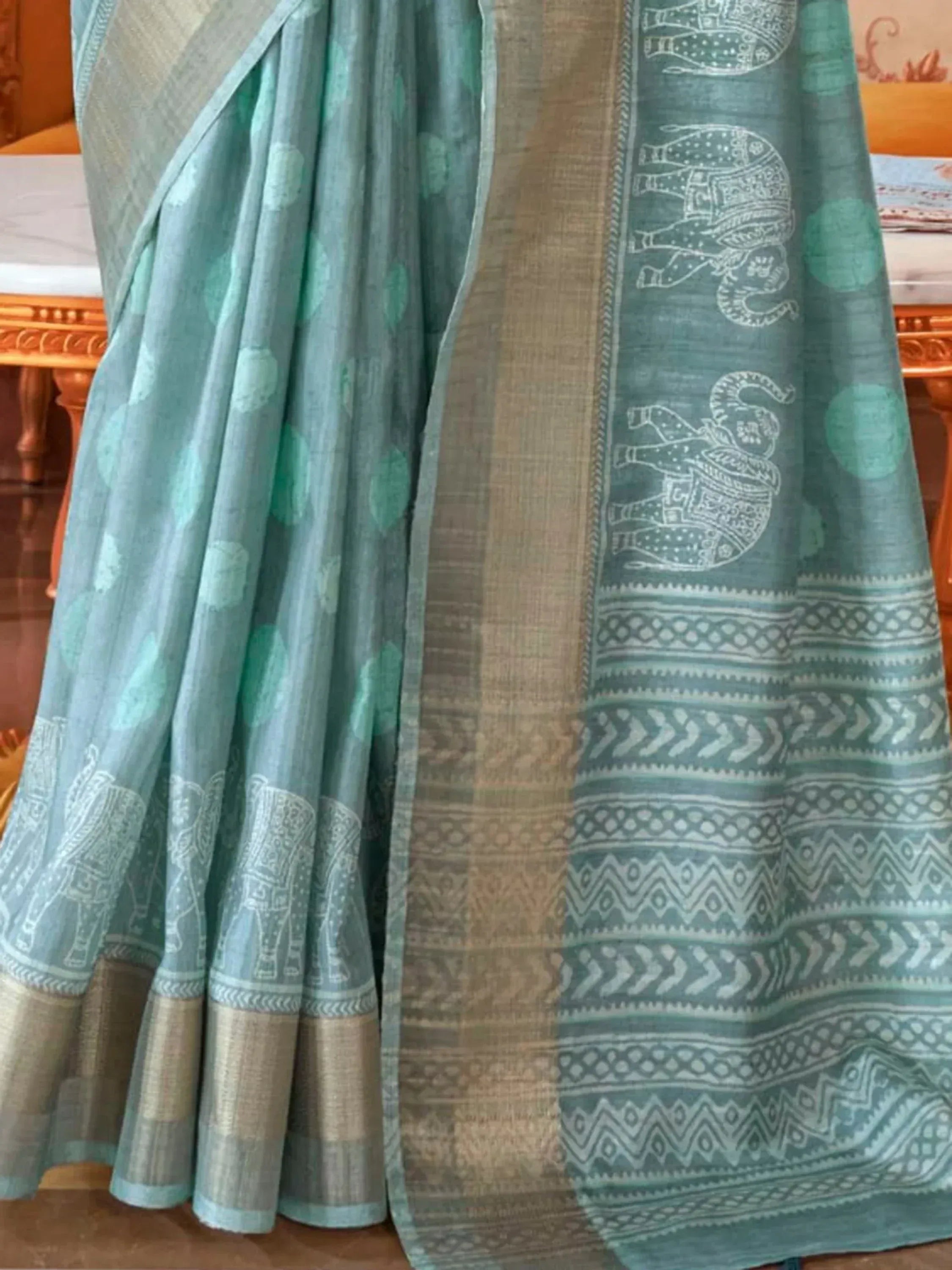 Teal saree with white elephant print and geometric border, Indian ethnic wear