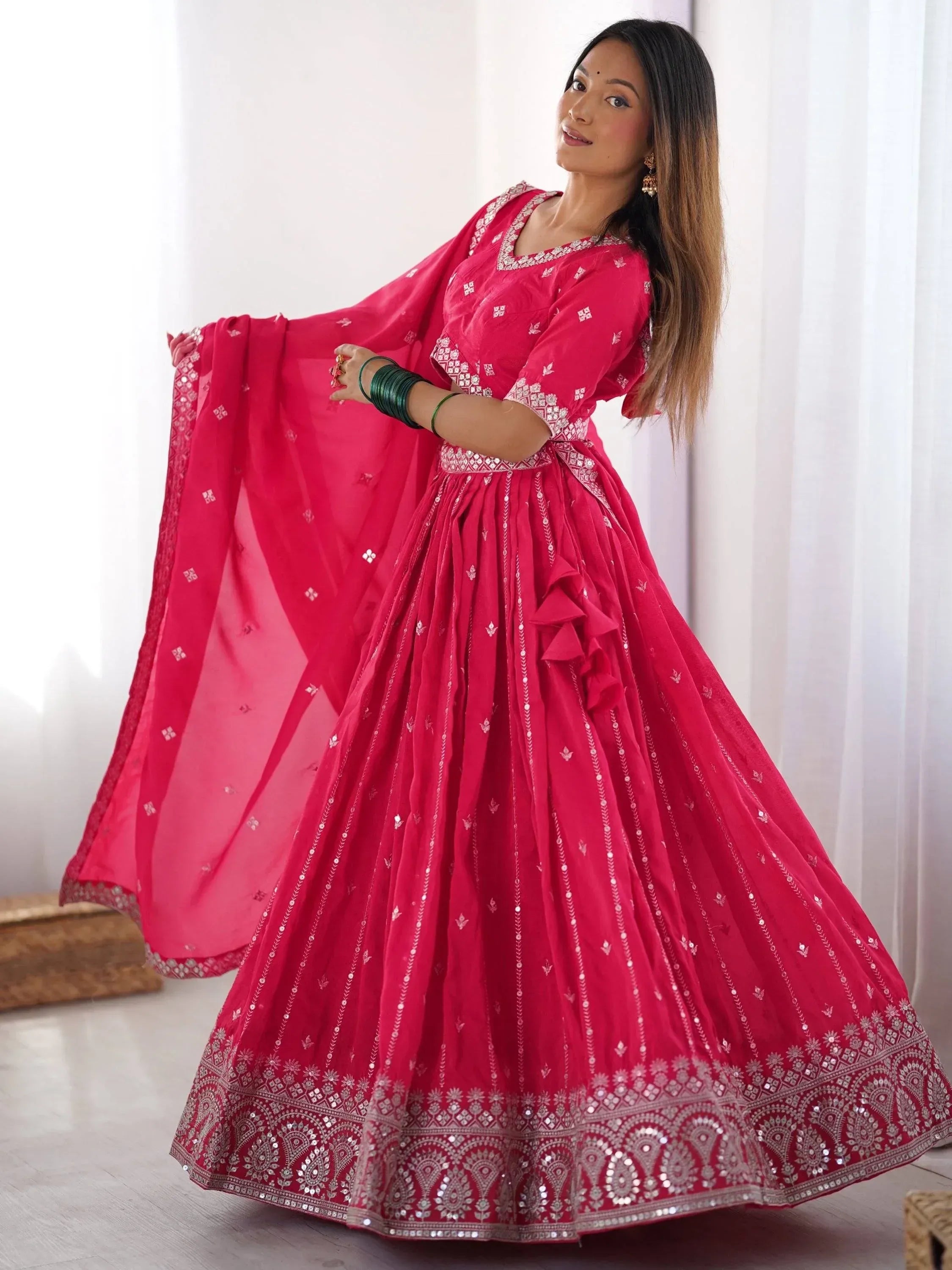 Pink designer lehenga choli with mirror work and ruffles, perfect for Indian ethnic wear