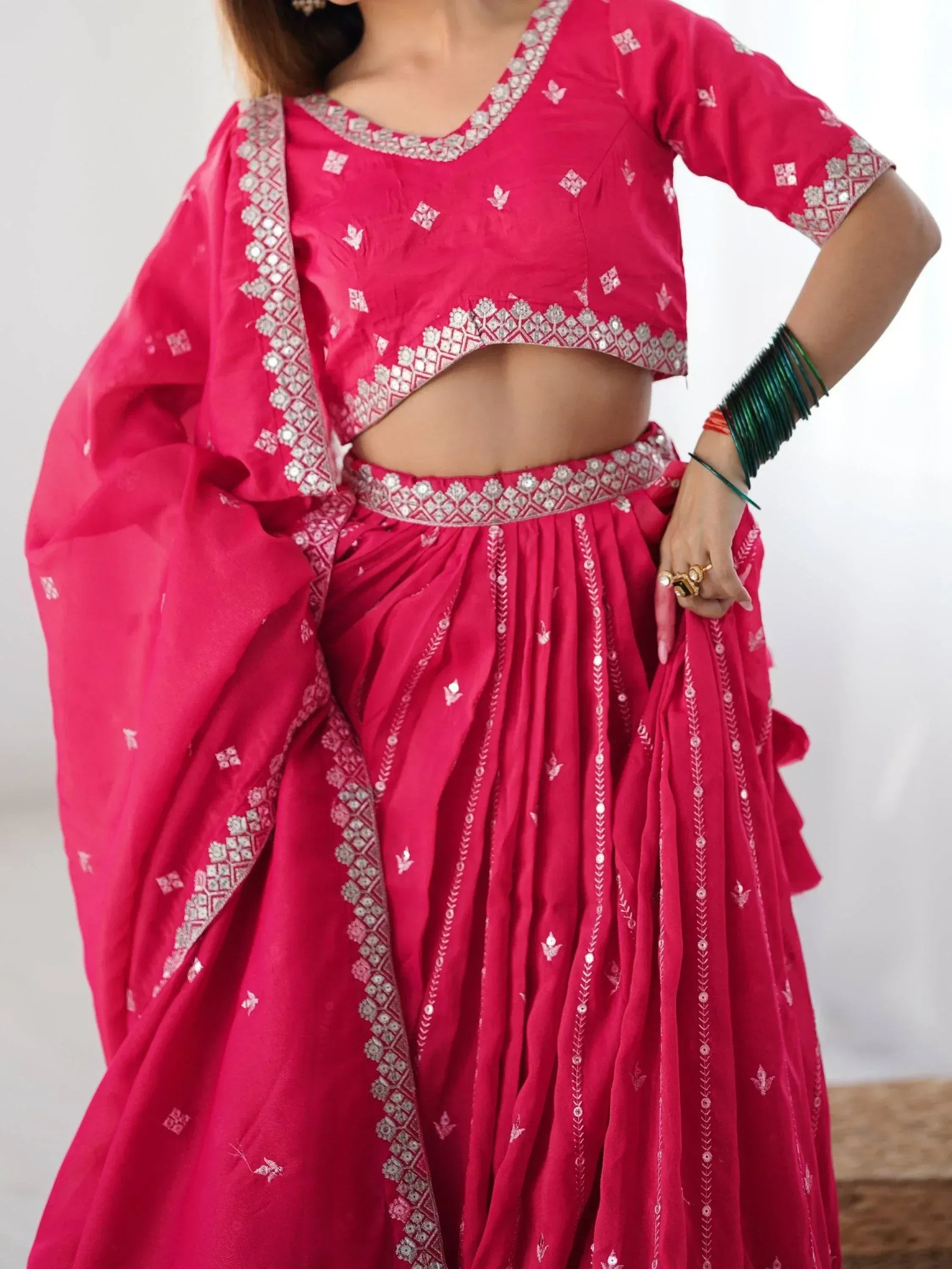 Pink ethnic lehenga choli with mirror work and embroidery, perfect for Indian celebrations