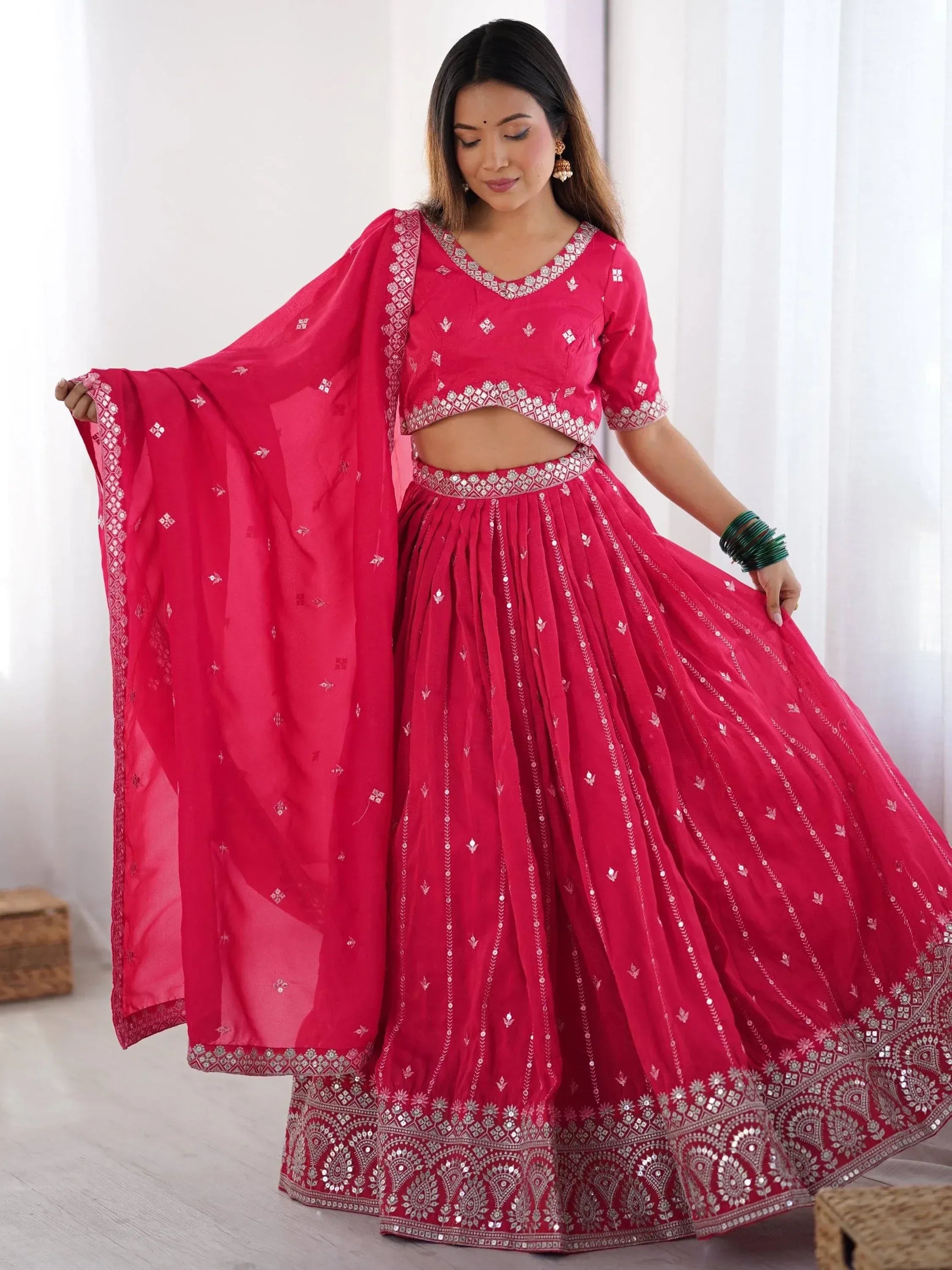 Red embroidered lehenga choli with mirror work, perfect for Indian ethnic wear and festive occasions.