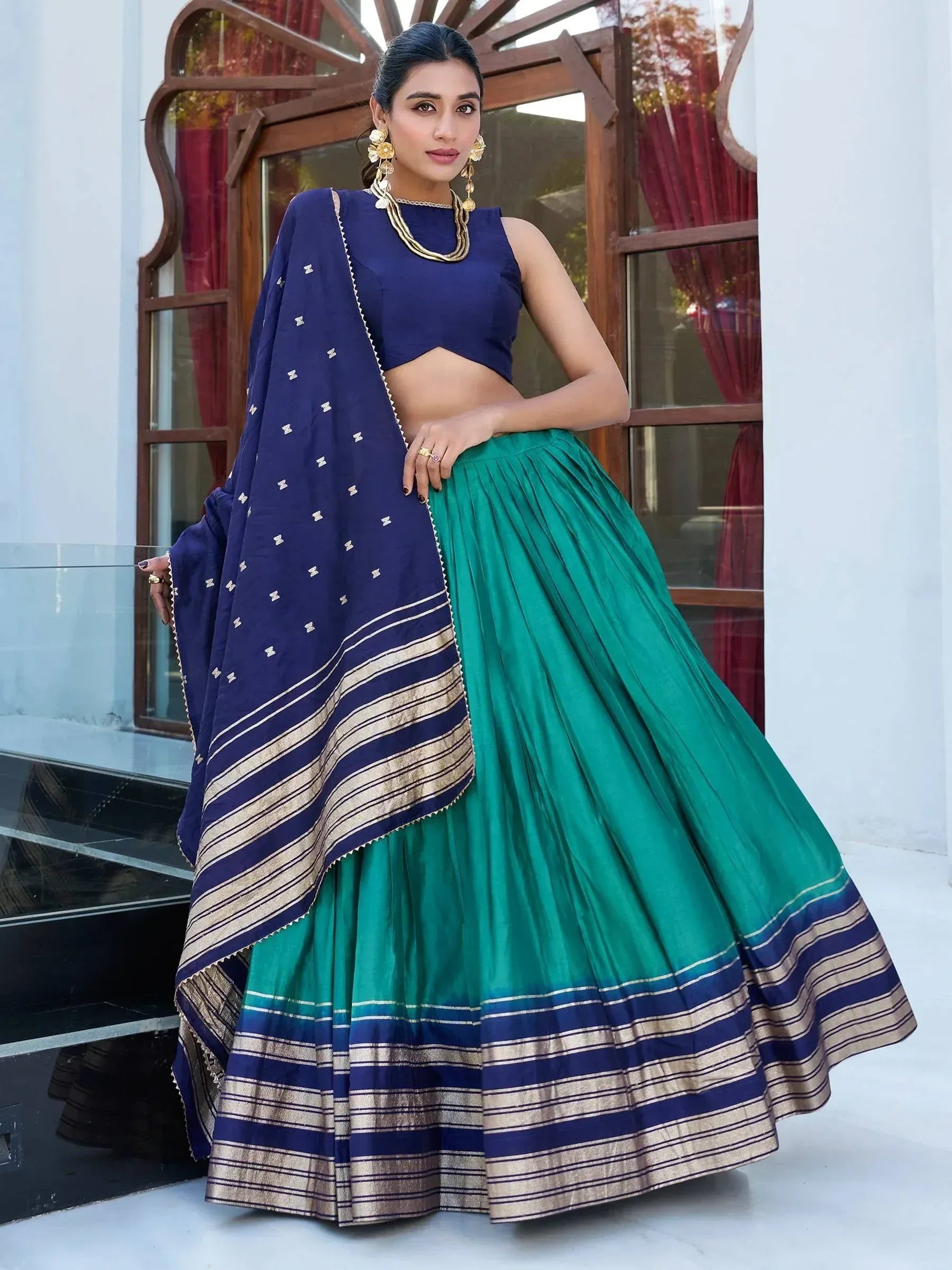 Navy blue and emerald green lehenga choli with gold stripes, perfect for Indian ethnic wear occasions