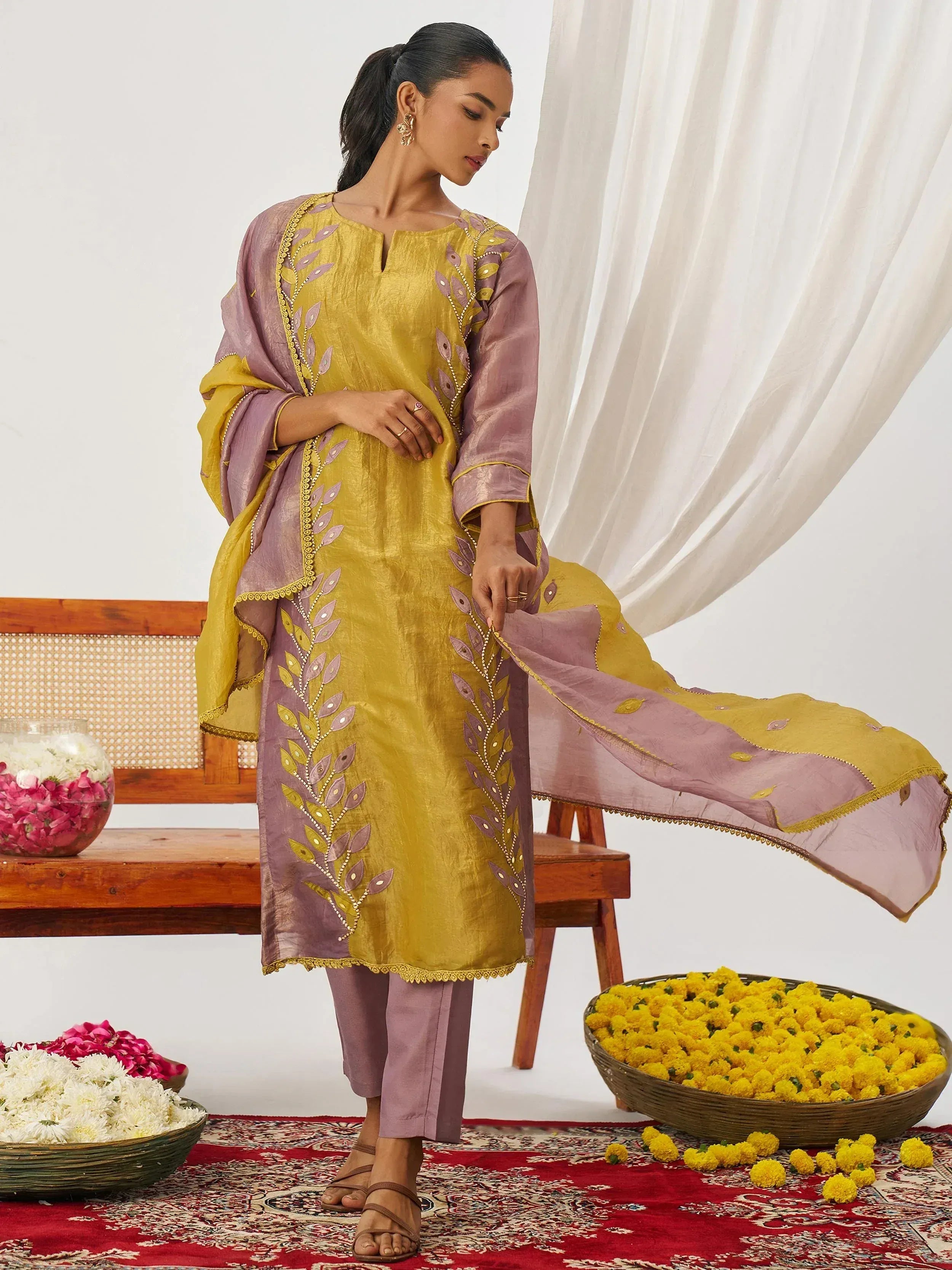 Yellow and mauve embroidered salwar kameez with floral motifs, perfect for Indian ethnic wear occasions.