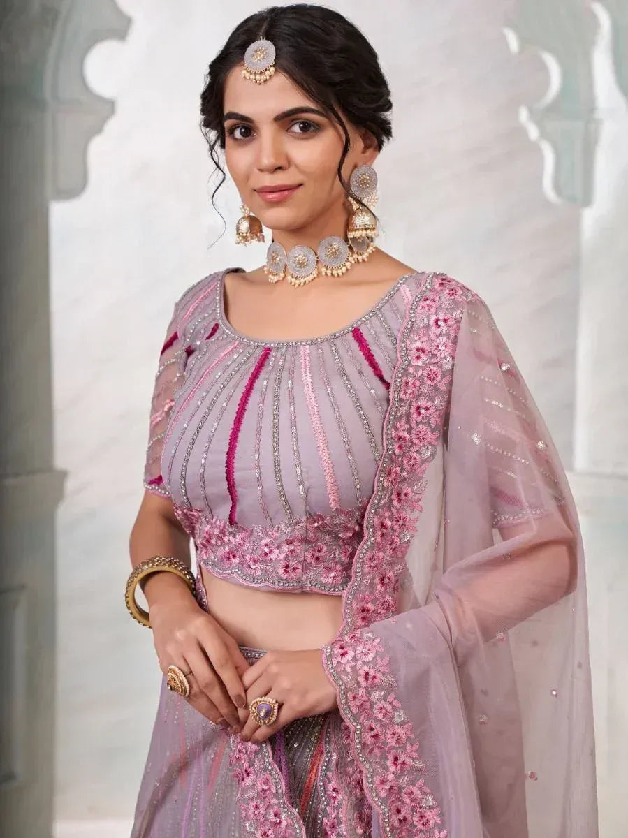 Elegant lavender lehenga choli with pink floral embroidery and sequin detailing, perfect for Indian ethnic wear occasions.