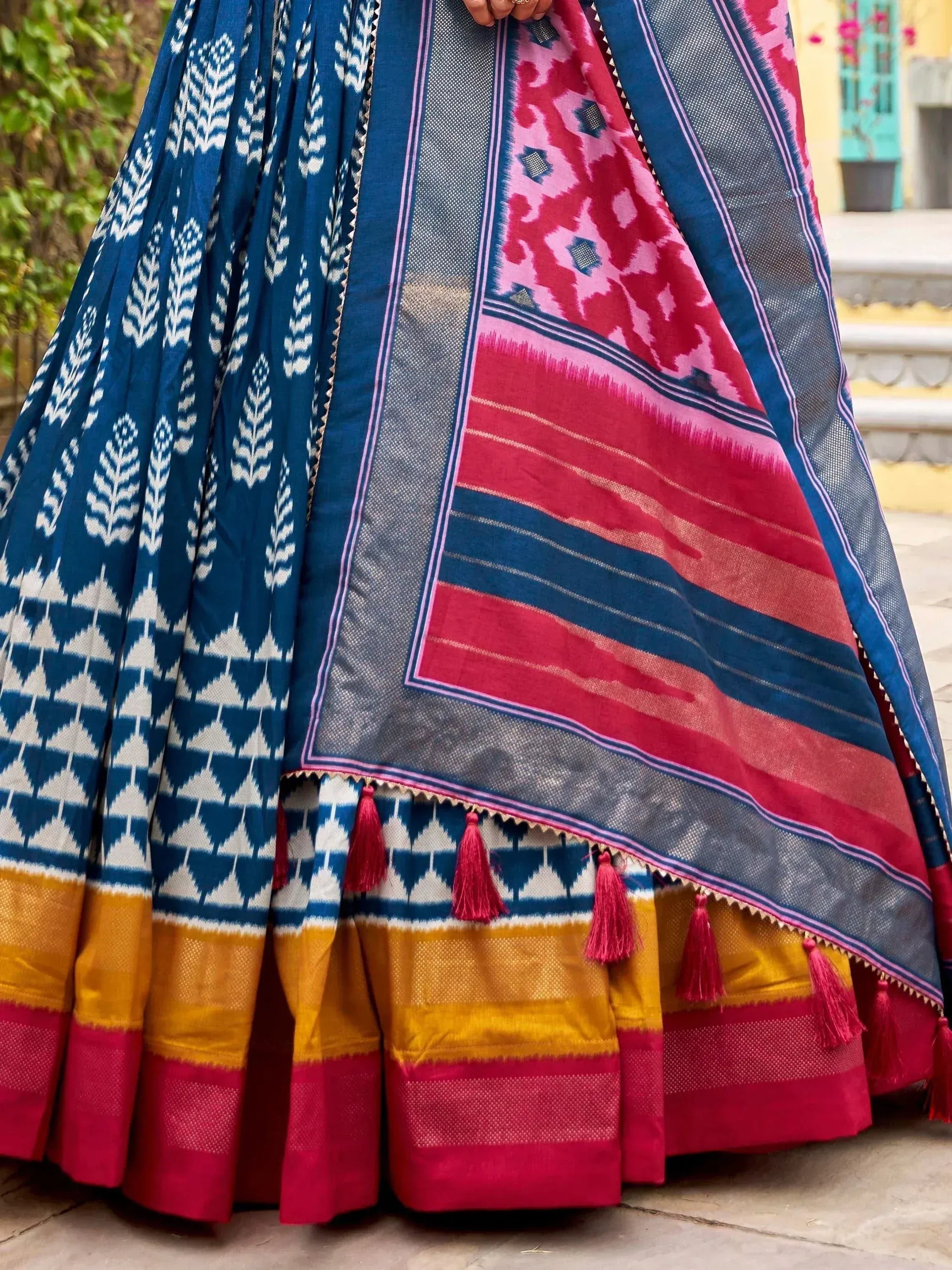Blue and pink ikat lehenga with tassels, ethnic Indian wear, vibrant patterns, traditional design