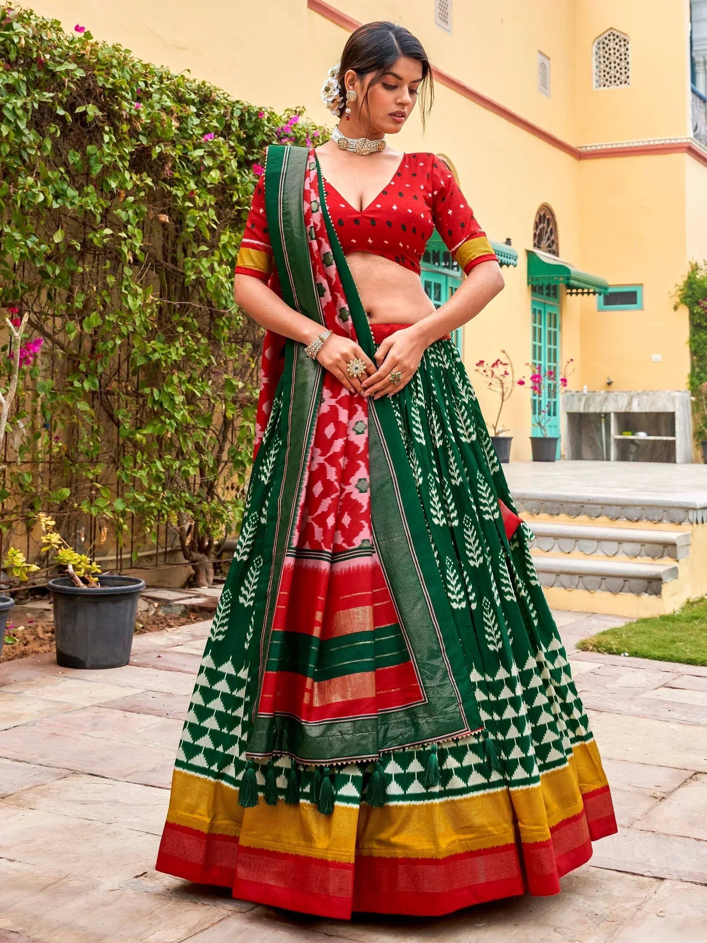 Red and green printed lehenga choli with ethnic patterns, perfect for Indian weddings and festivals