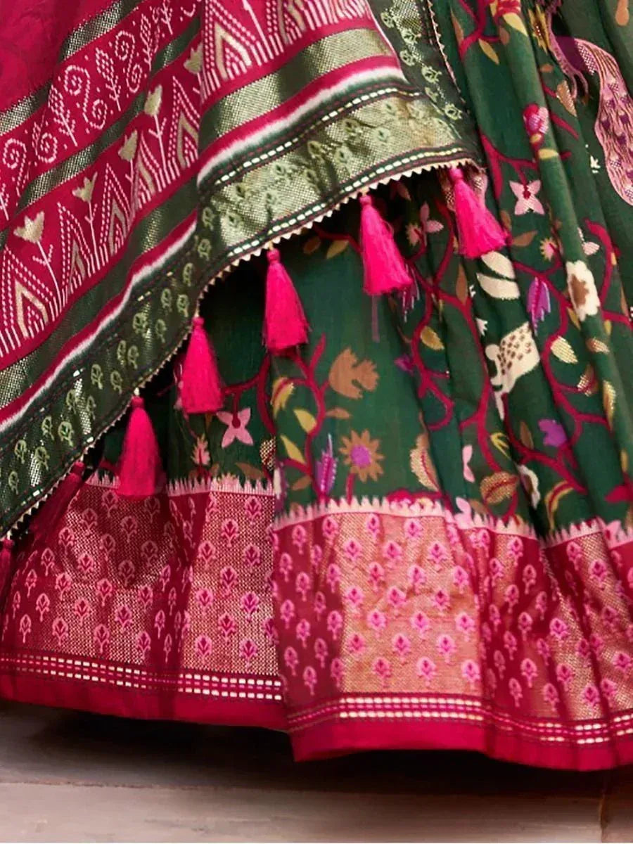 Green and pink floral lehenga with tassels and intricate embroidery, perfect for Indian ethnic wear