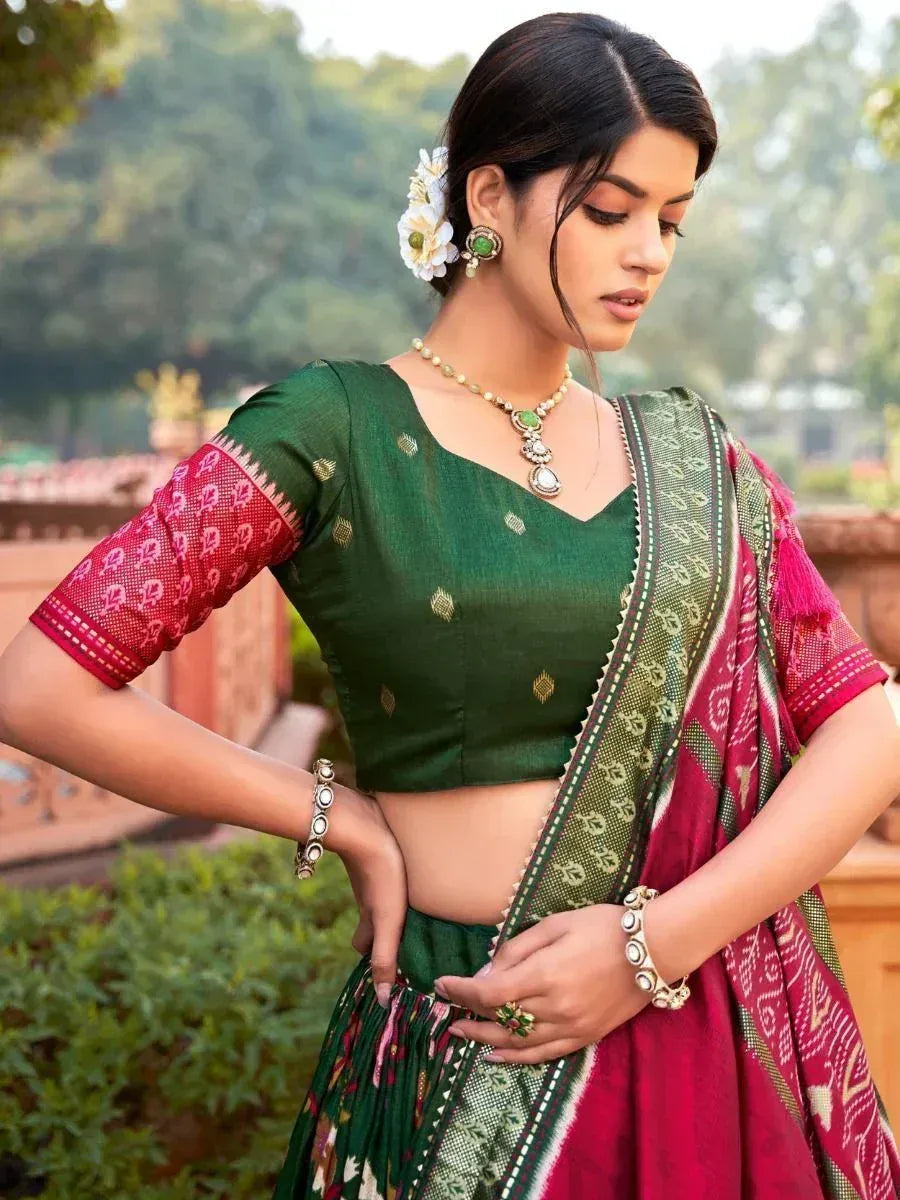 Green and pink ethnic lehenga choli with floral jewelry, perfect for Indian weddings and festivals.