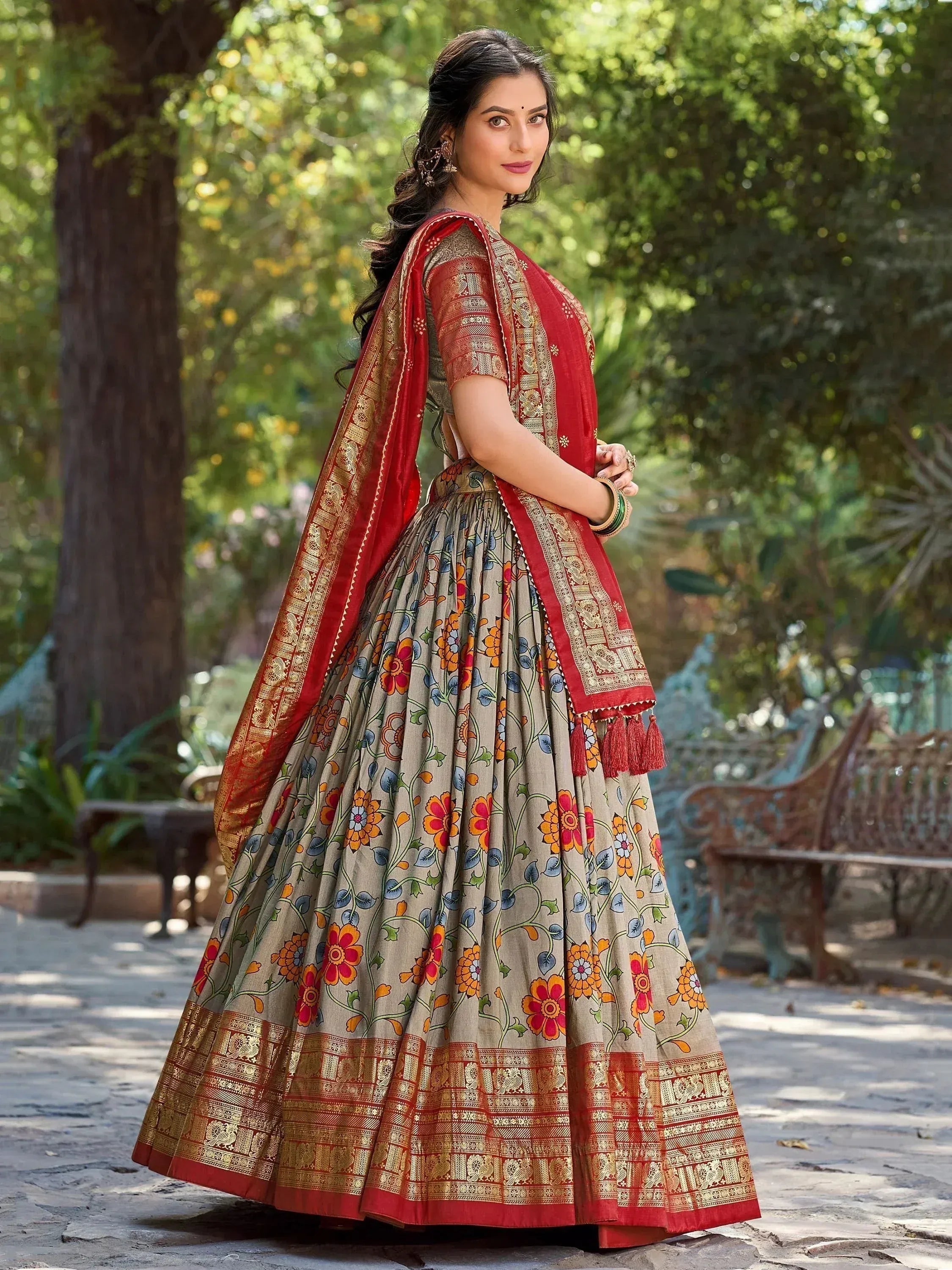 Woman in floral print lehenga choli with red dupatta, ethnic Indian wear for festive occasions