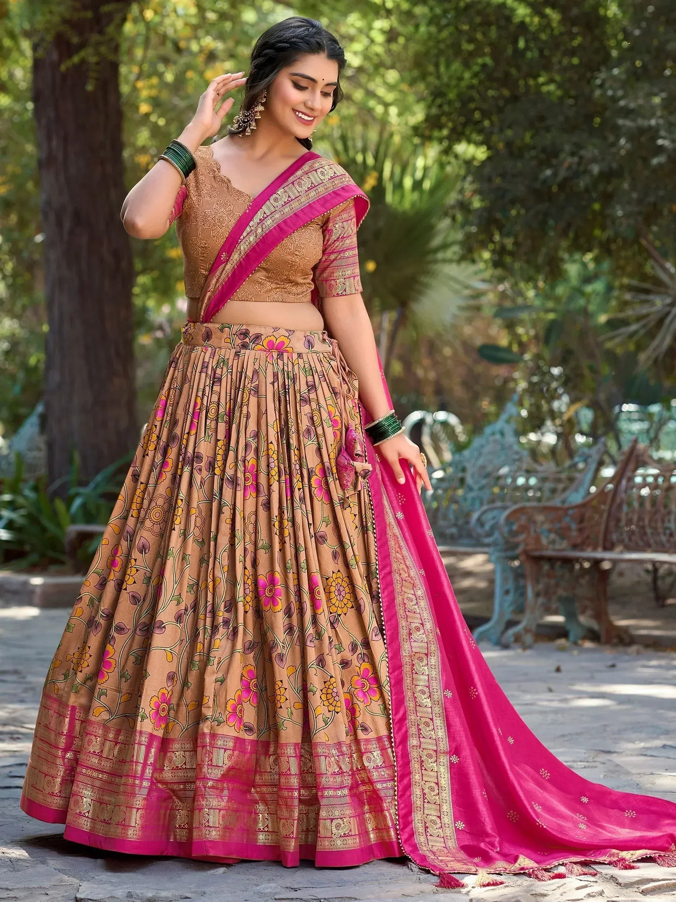 Woman in floral print lehenga choli with pink dupatta, ethnic Indian wear for festive occasions