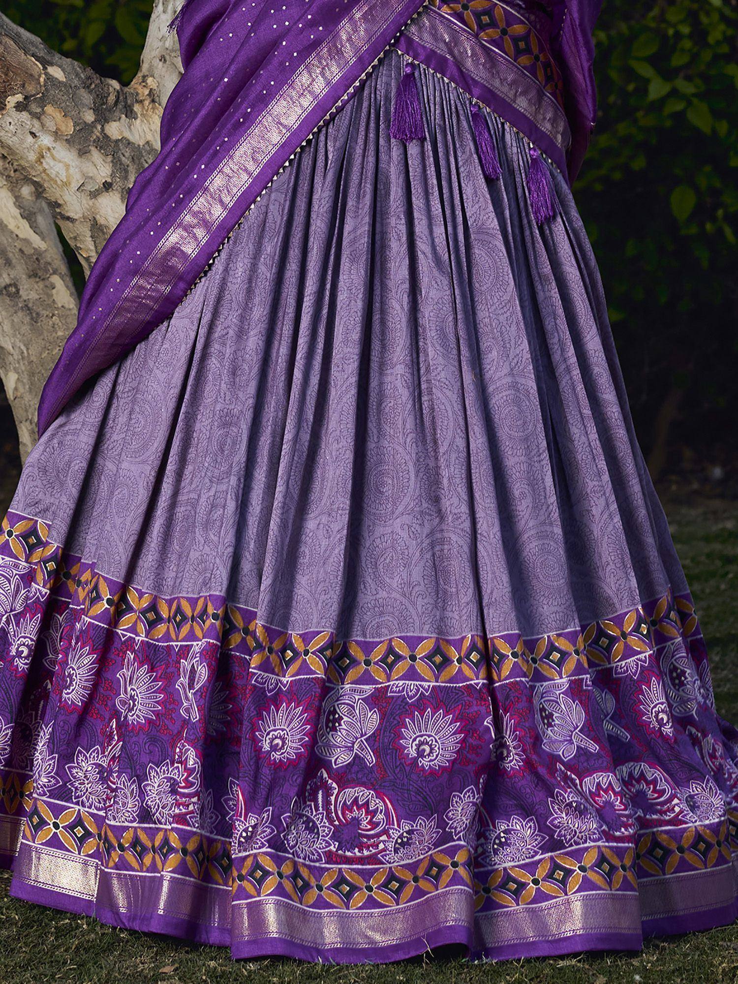 Purple printed lehenga choli with floral border and tassels, ethnic Indian wear for women