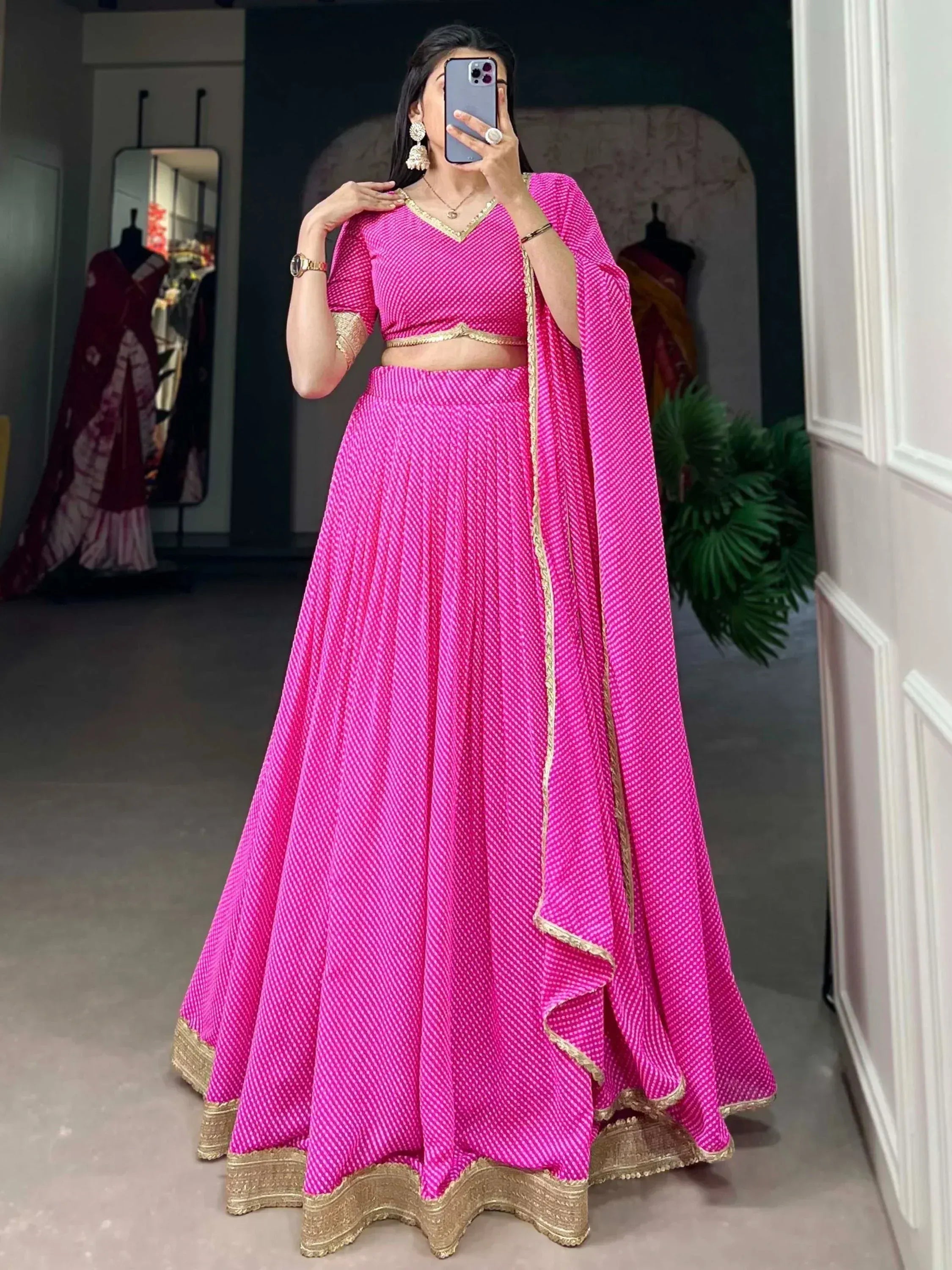 Vibrant pink lehenga choli with gold trim, perfect for Indian ethnic wear and festive occasions.