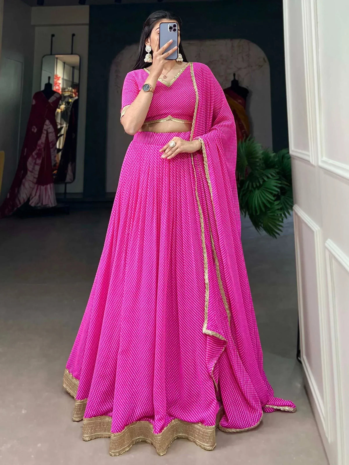 Vibrant pink lehenga choli with gold trim, perfect for Indian ethnic wear and festive occasions.
