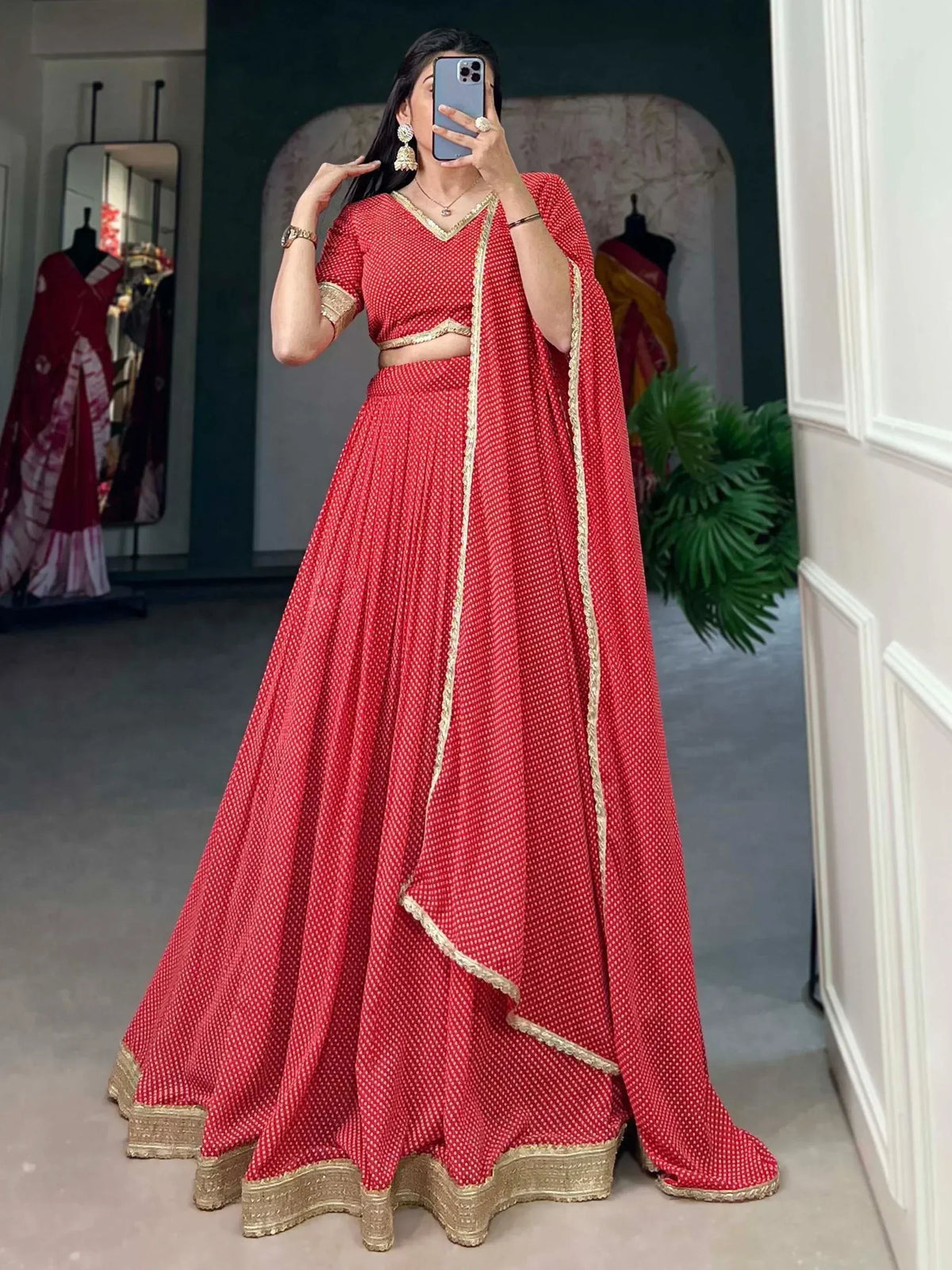 Red printed lehenga choli with gold trim, perfect for Indian ethnic wear and festive occasions.