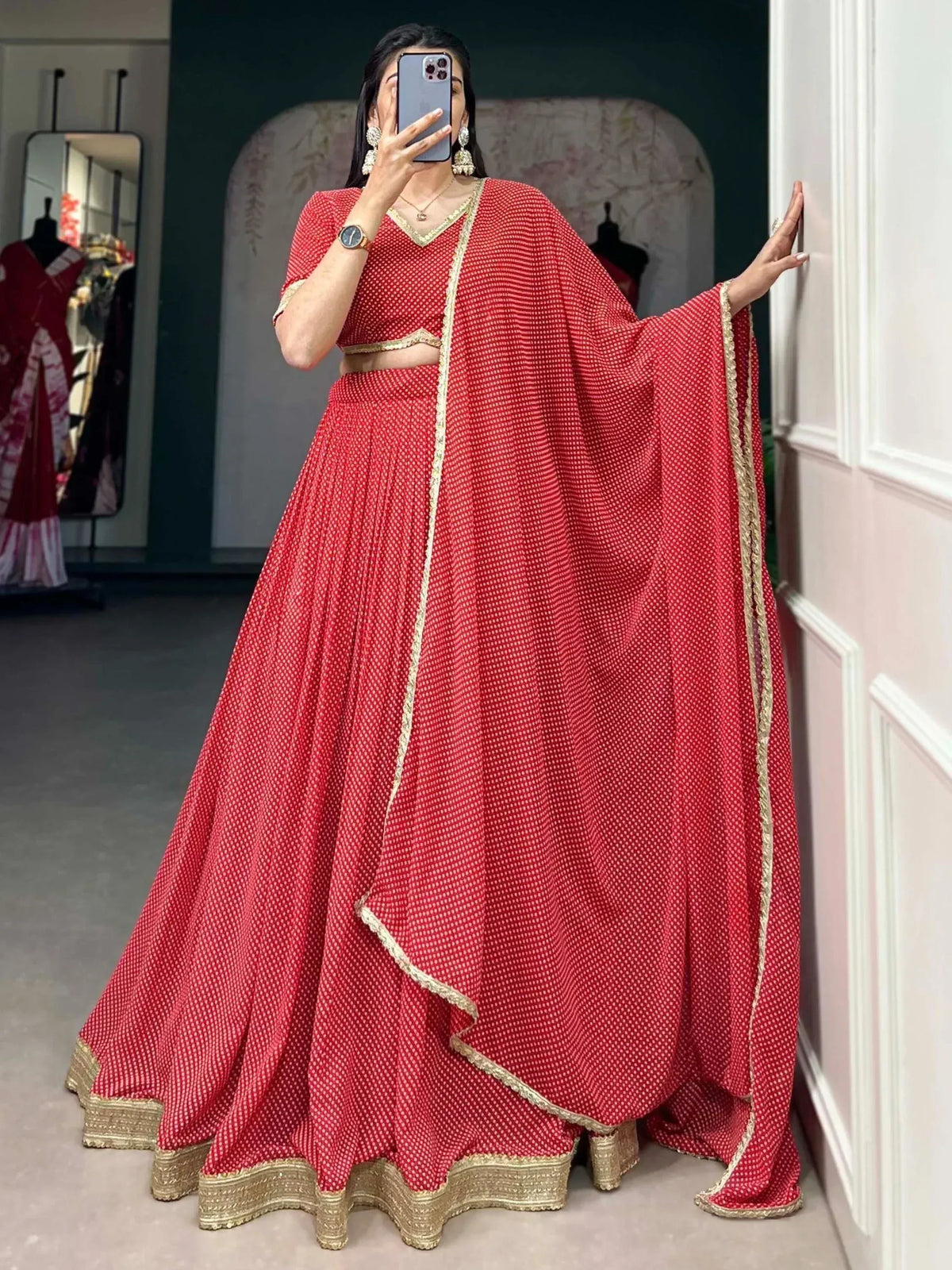 Red ethnic lehenga choli with gold trim, perfect for Indian weddings and festive occasions.