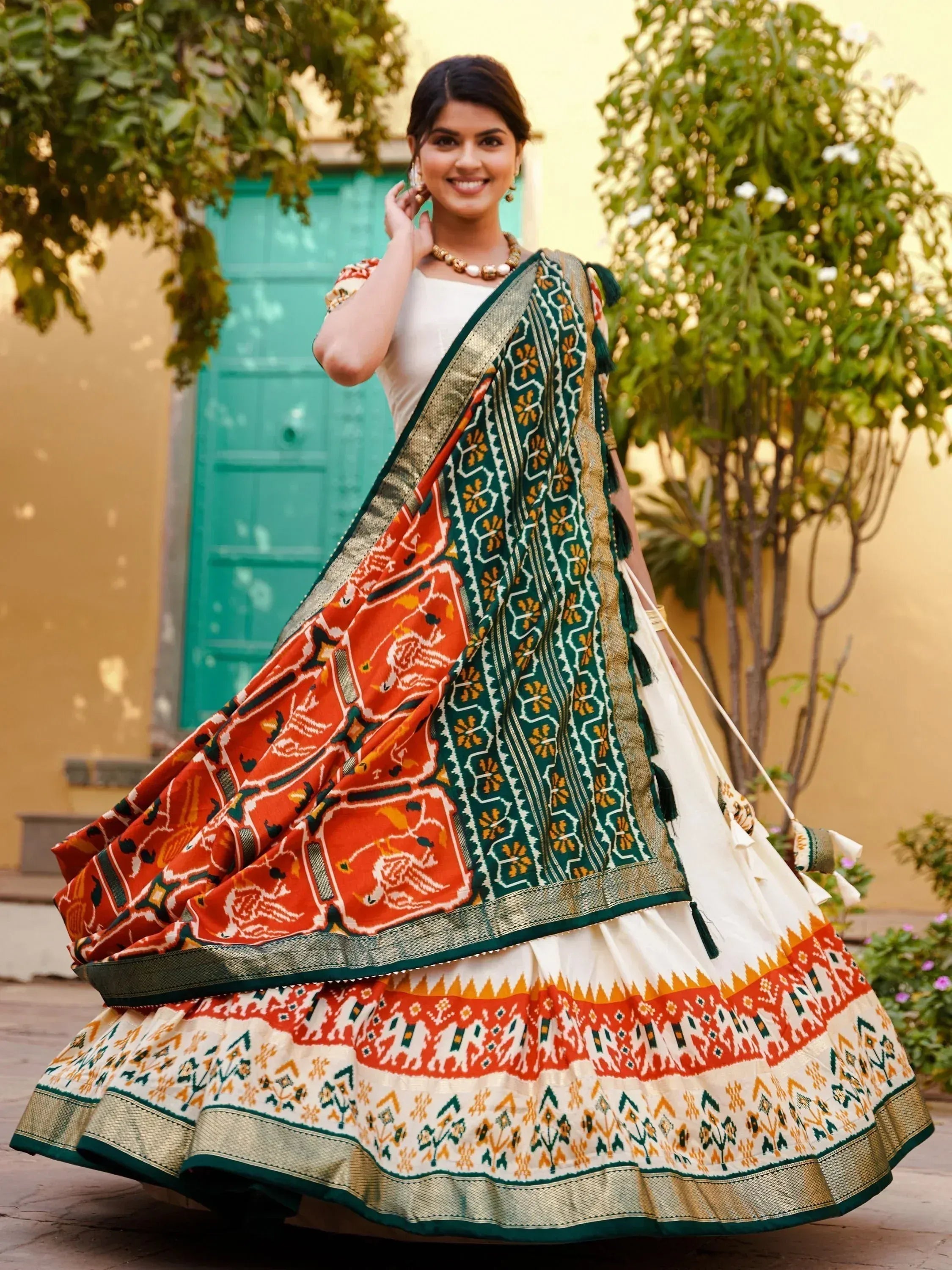 Woman in vibrant ethnic lehenga choli with floral and geometric prints, perfect for Indian celebrations