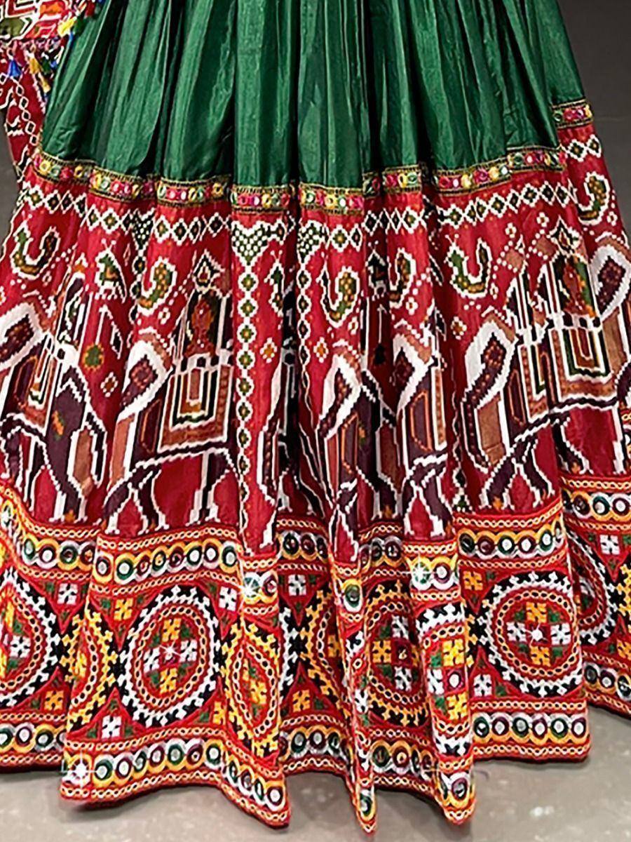 Green and red embroidered lehenga skirt with intricate geometric patterns, perfect for Indian ethnic wear.