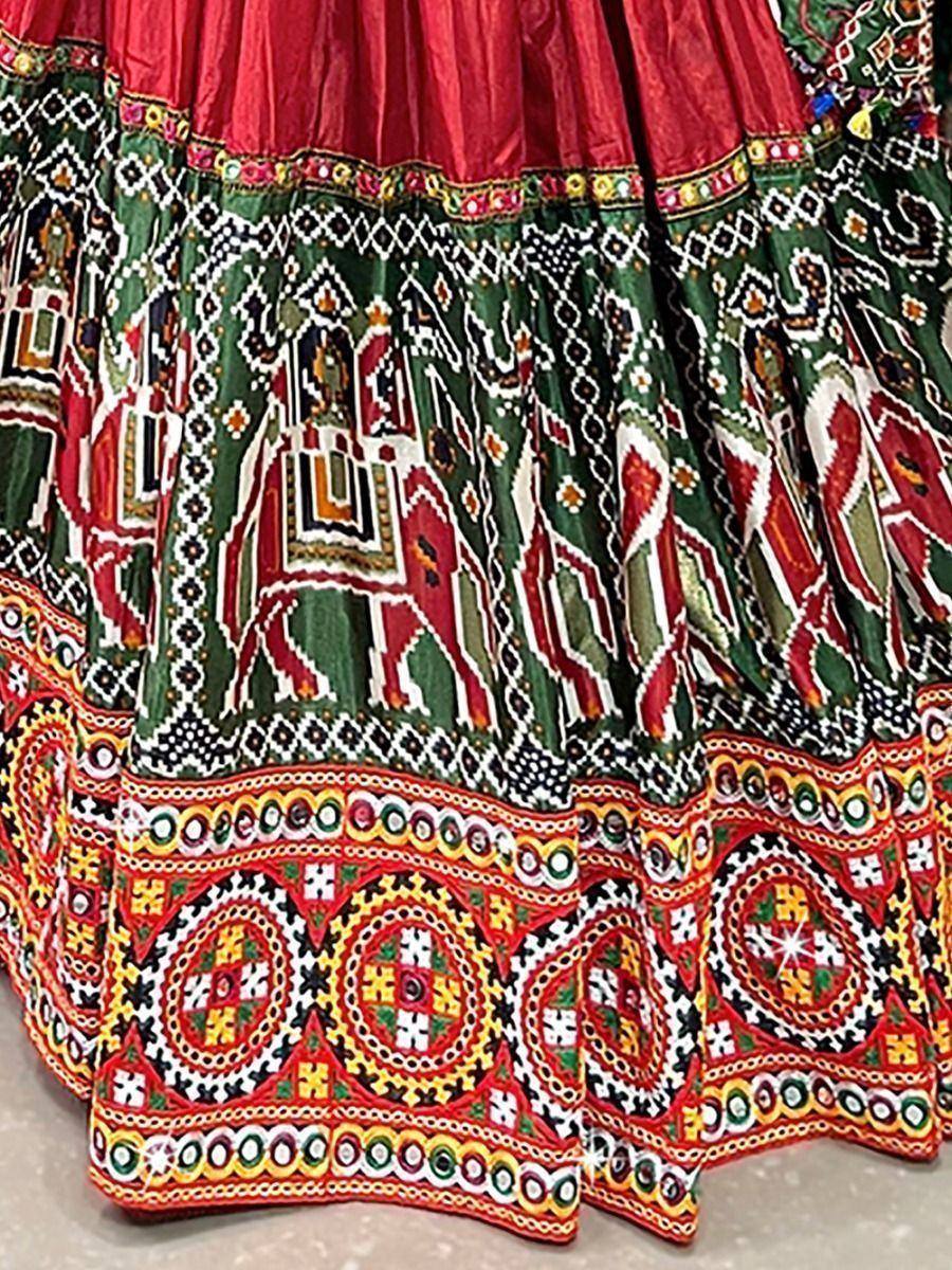 Vibrant red and green ethnic lehenga skirt with intricate elephant and geometric mirror work embroidery