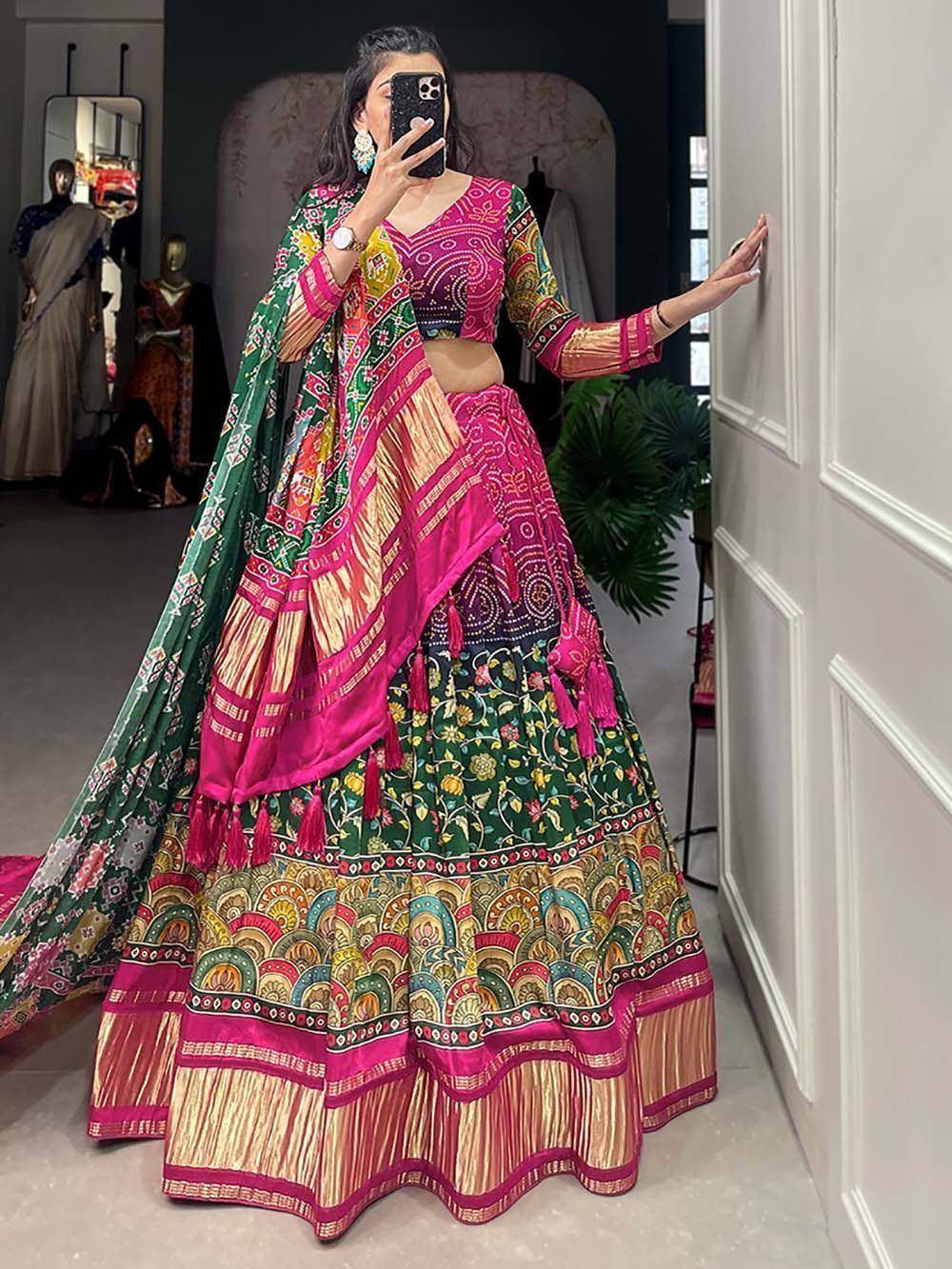 Vibrant pink and green printed lehenga choli with floral motifs and tassels, perfect for Indian ethnic occasions