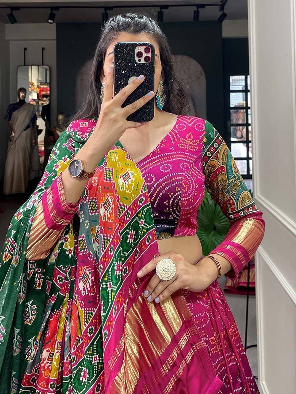 Vibrant pink and green printed lehenga choli with ethnic patterns, perfect for Indian festive occasions.