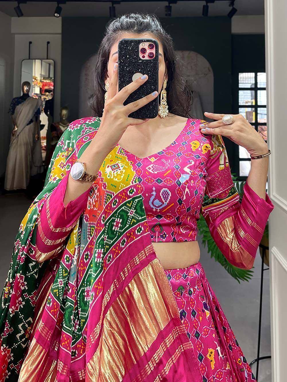 Vibrant pink and green printed lehenga choli with peacock motifs, perfect for festive Indian occasions.