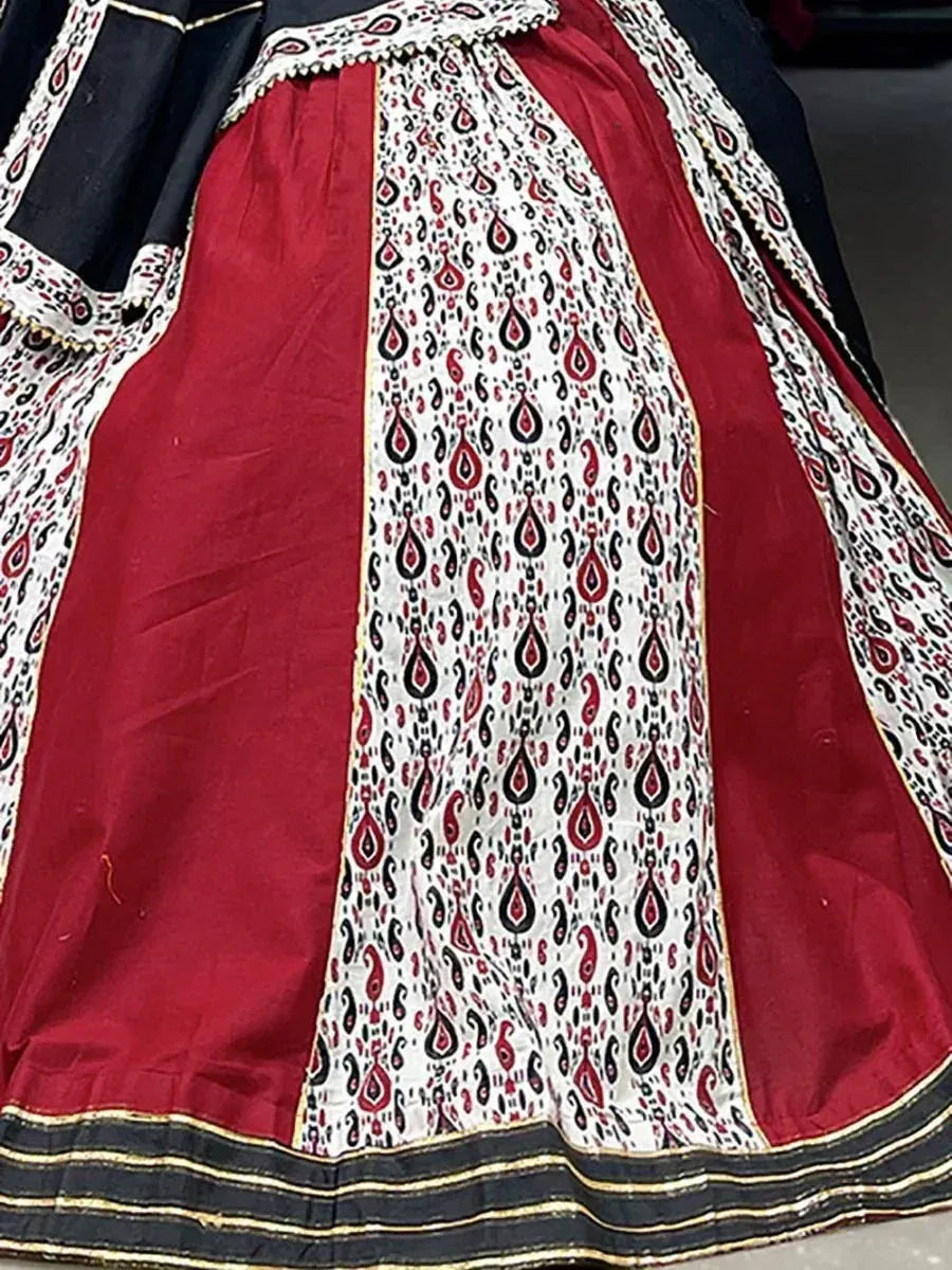 Red and white ethnic lehenga skirt with black paisley print and gold trim, Indian designer wear