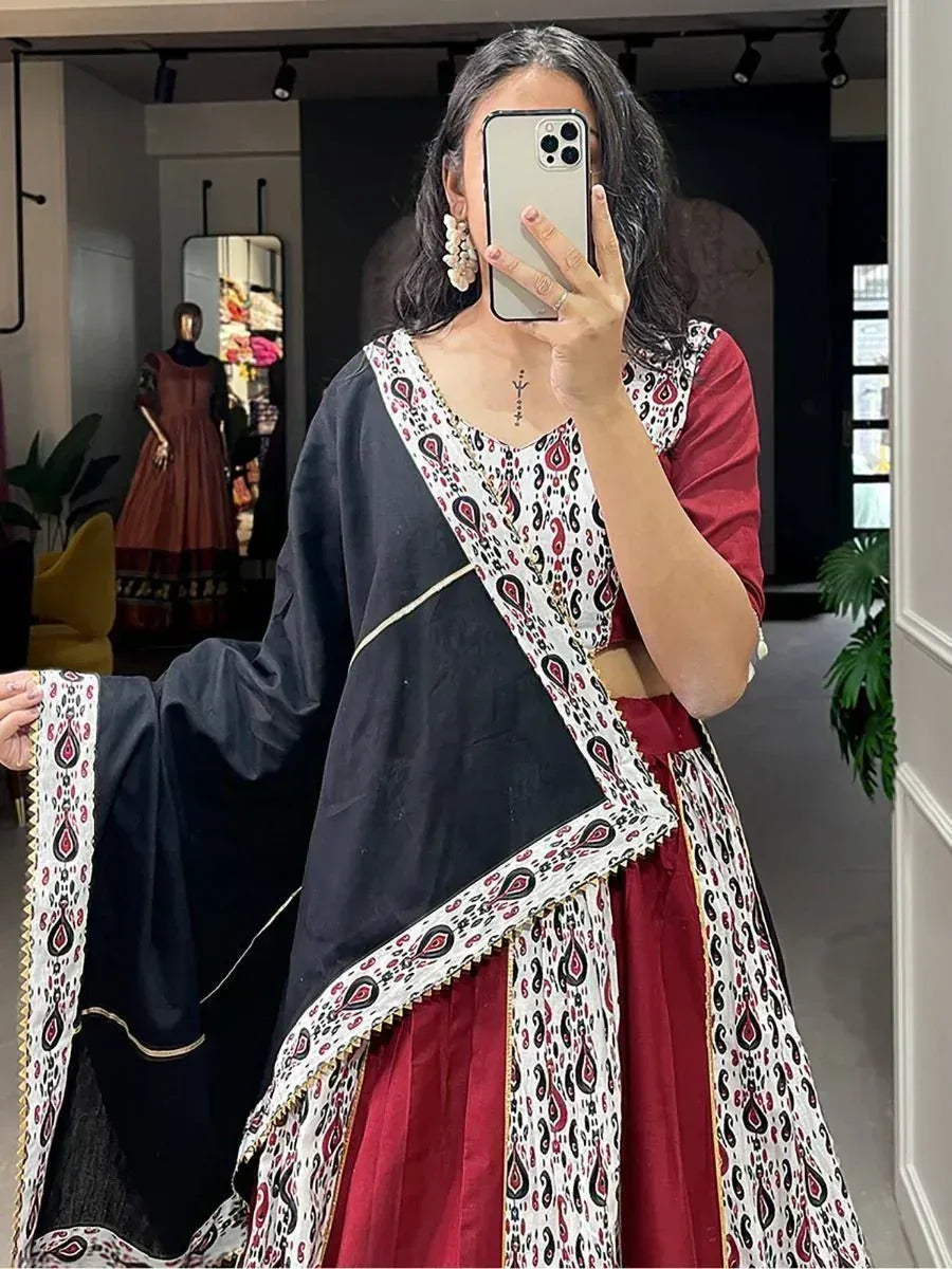 Woman wearing maroon and black ethnic salwar kameez with paisley print dupatta, perfect for Indian occasions