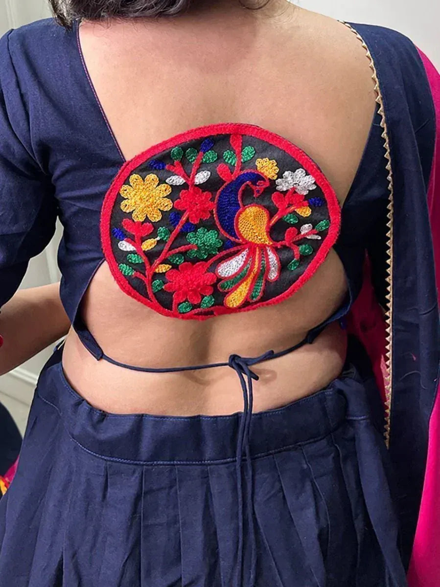 Navy blue backless blouse with peacock and floral embroidery, paired with ethnic skirt