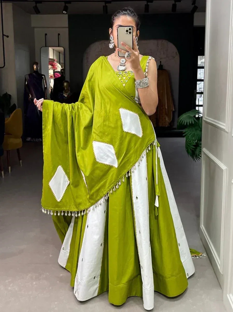 Green and white ethnic lehenga choli with diamond patches and tassels, perfect for festive occasions