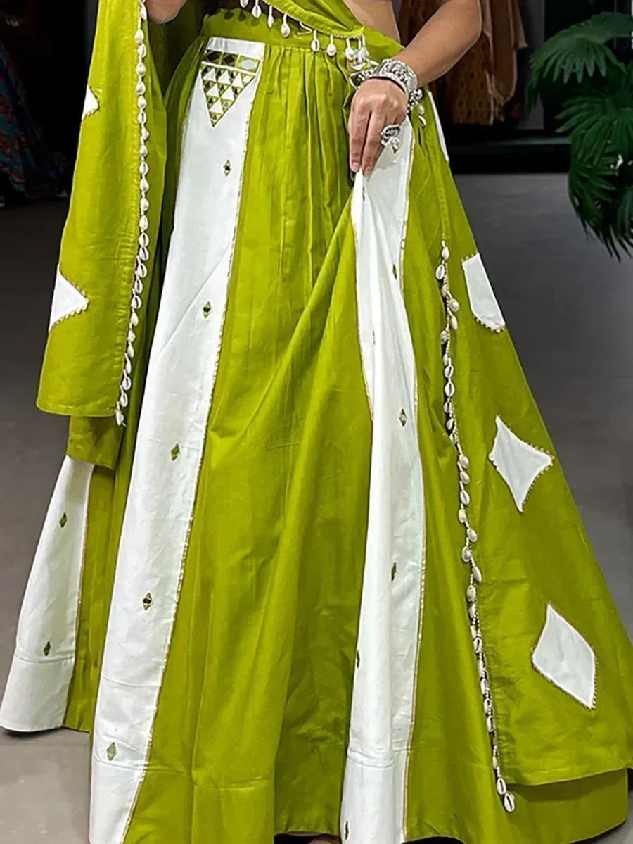 Vibrant green and white ethnic lehenga with shell embellishments and mirror work, perfect for festive occasions.