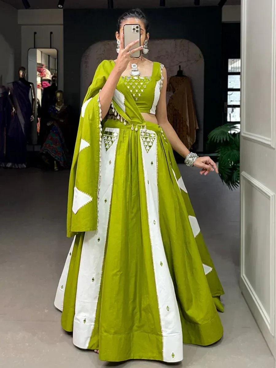 Vibrant green and white designer lehenga choli with geometric embroidery, perfect for Indian ethnic wear occasions.