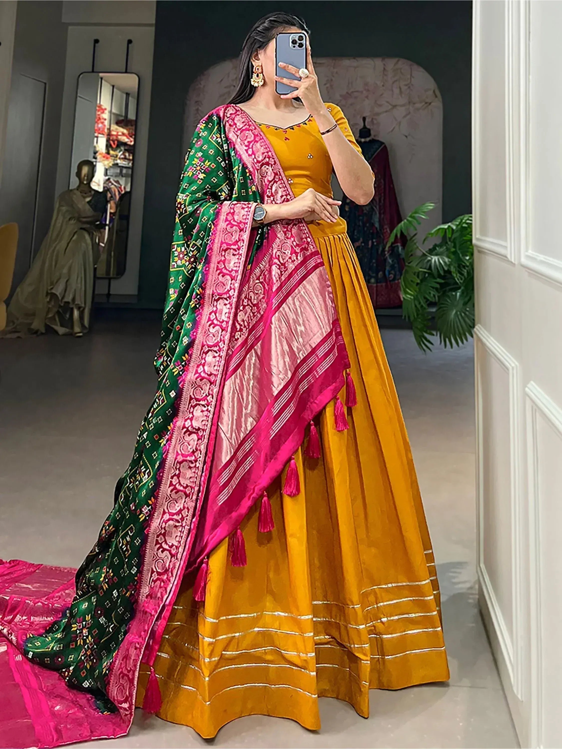 Yellow velvet lehenga choli with pink and green embroidered dupatta, ethnic Indian wear