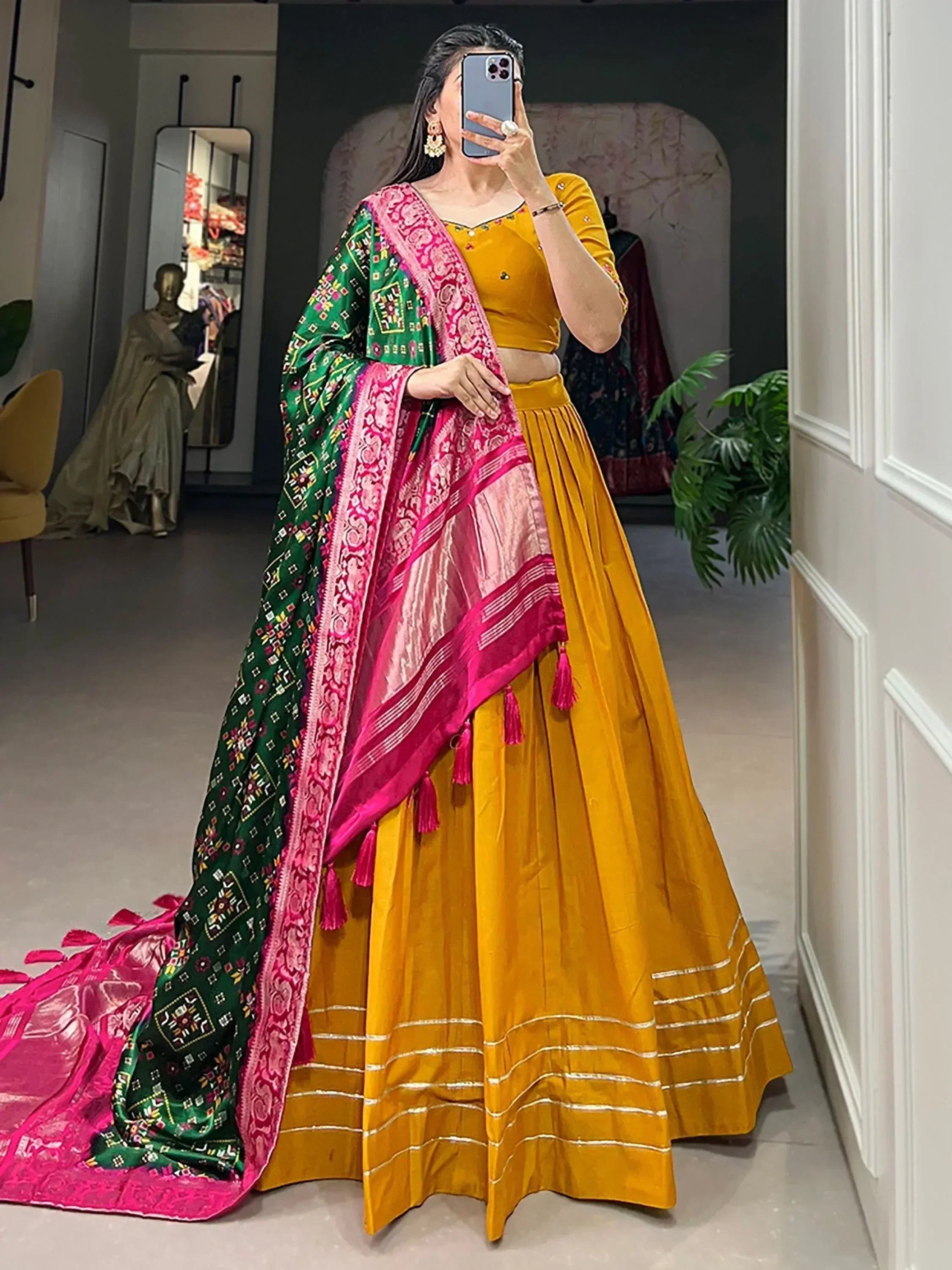 Mustard yellow lehenga choli with green and pink embroidered dupatta, ethnic Indian wear