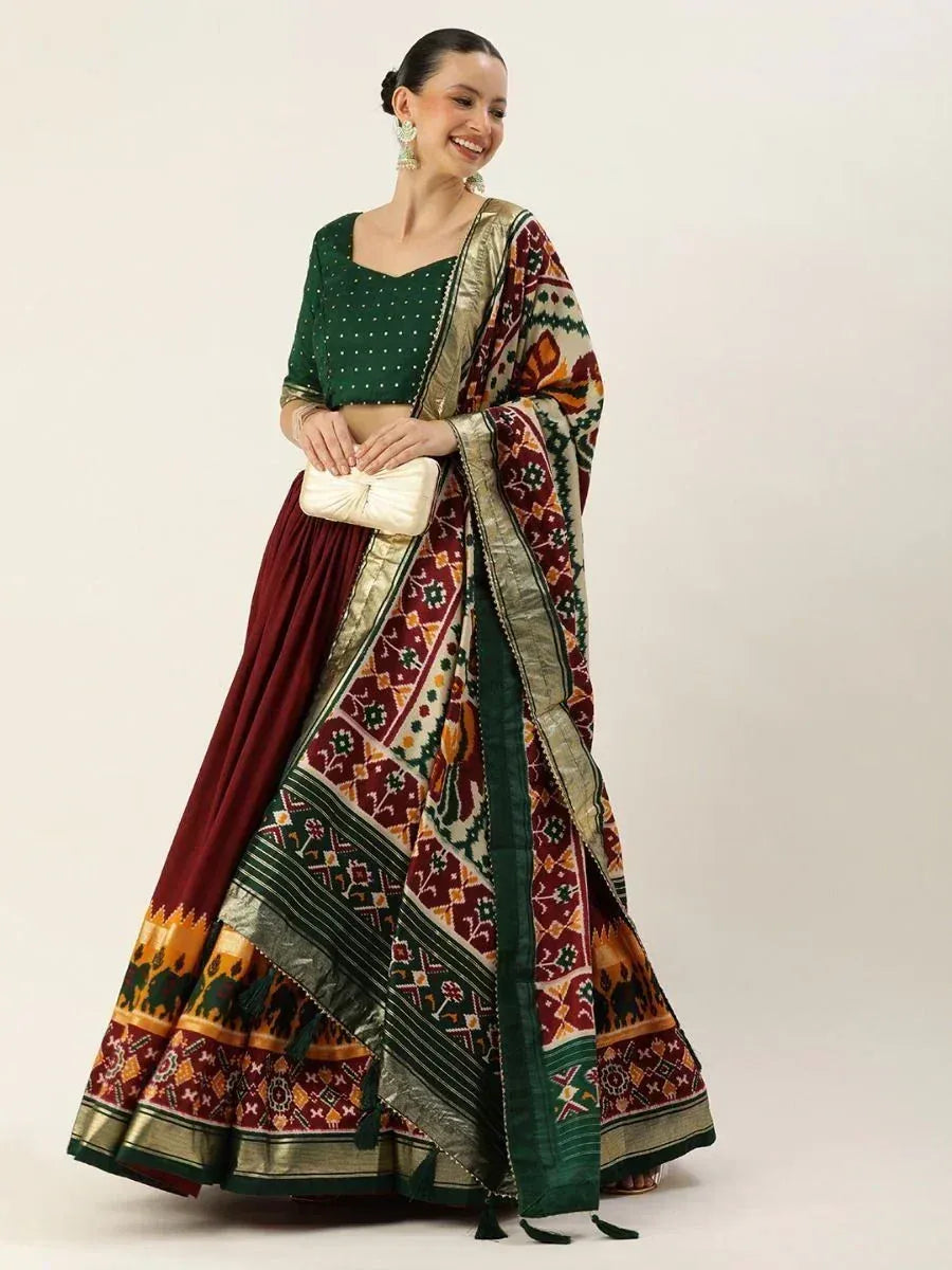 Green and maroon ethnic lehenga choli with printed dupatta, perfect for Indian weddings and festivals.