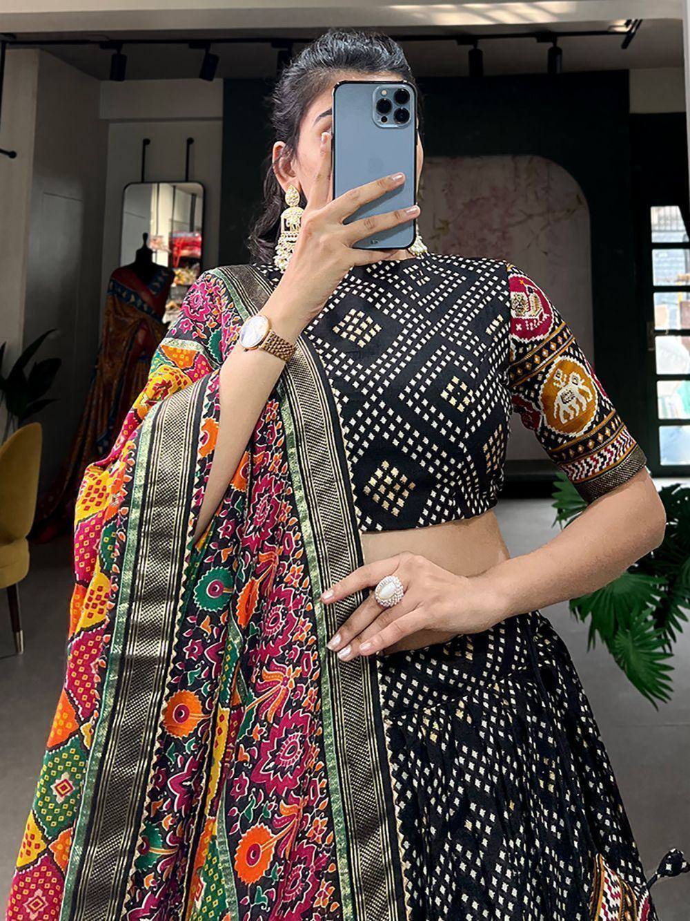 Woman in black embroidered lehenga choli with colorful printed dupatta, Indian ethnic wear