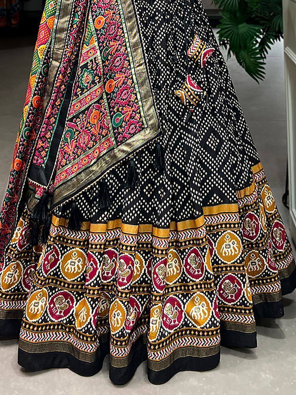 Black and gold ethnic lehenga with vibrant floral and elephant motifs, perfect for Indian weddings and festivals.