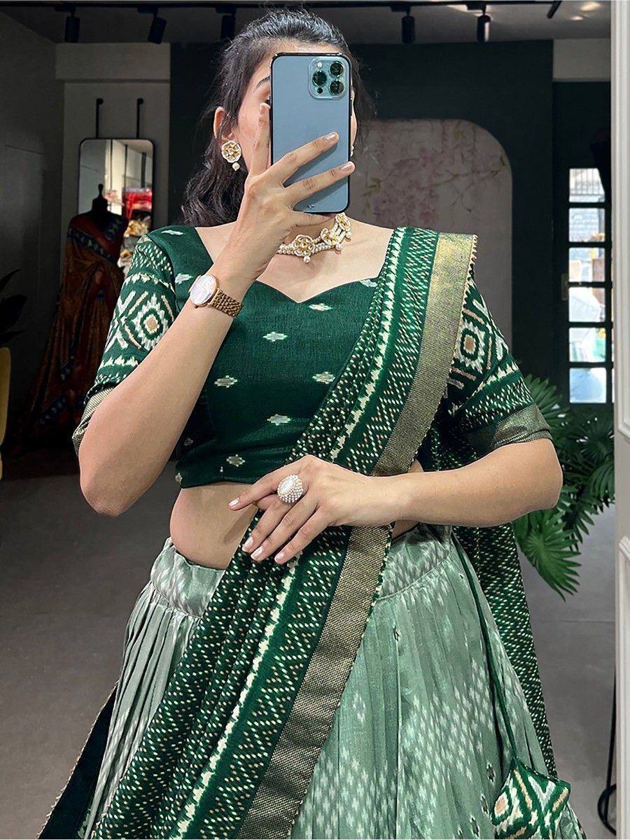 Green ikat print lehenga choli with gold border, perfect for ethnic occasions and Indian weddings