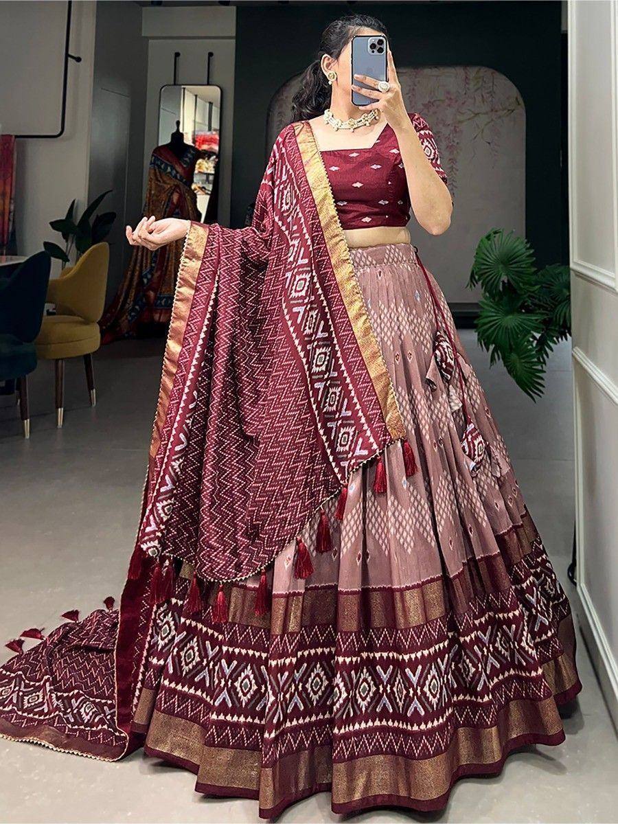 Maroon and pink printed lehenga choli with geometric patterns and gold border, perfect for Indian ethnic wear
