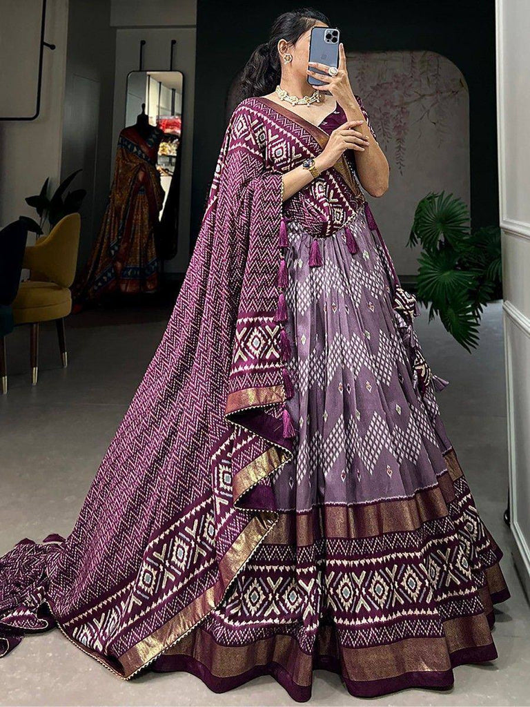 Purple printed lehenga choli with geometric patterns and tassels, perfect for Indian ethnic wear occasions