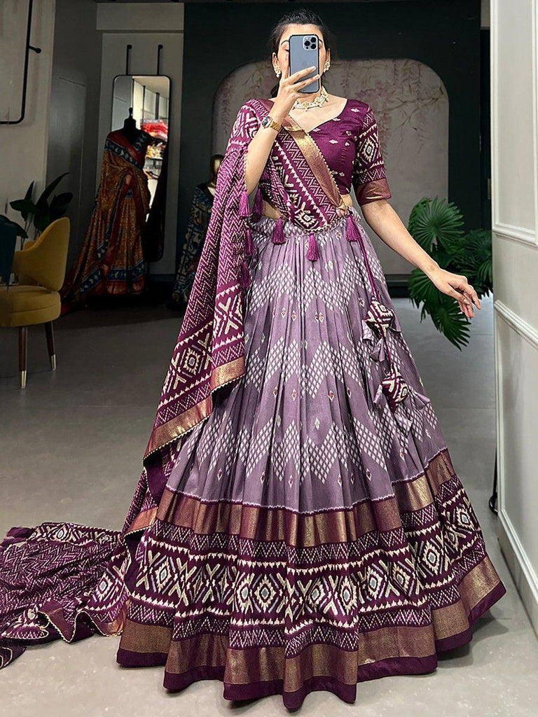 Purple printed lehenga choli with geometric patterns and gold trim, perfect for Indian ethnic wear occasions.